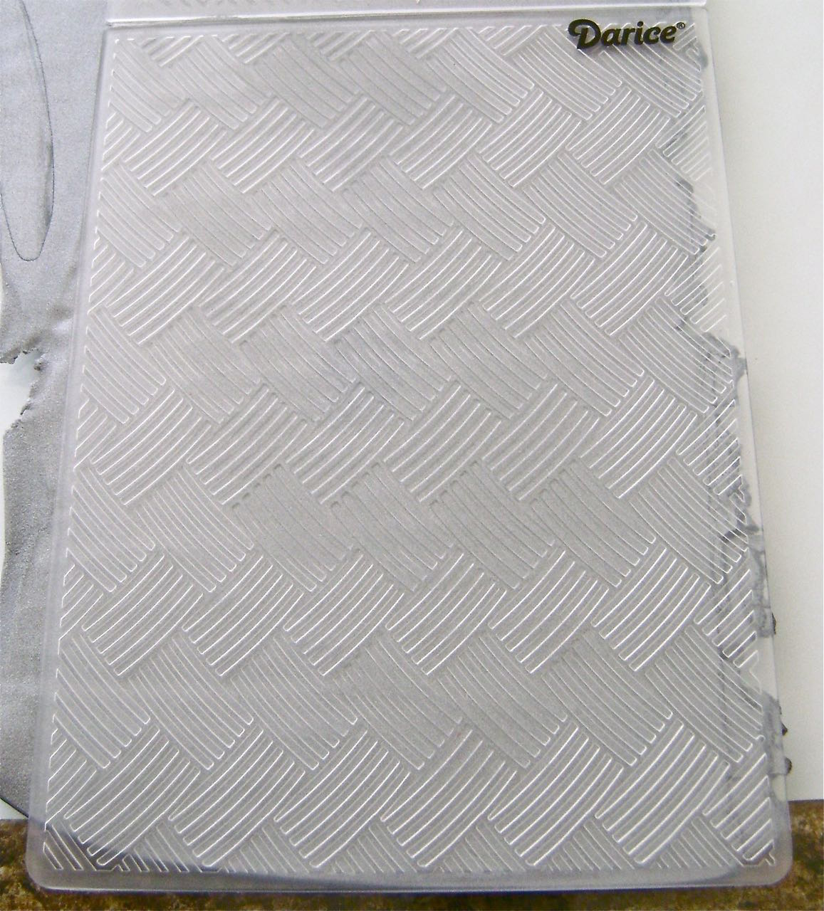 step 9 - Covering the work surface with wax paper will allow you to turn the work as needed. Place the clay pieces on the wax paper and cover them with the Basket Weave Embossing folder. Using pressure, roll across the folder. The folder is not large enough to cover all the clay. When you finish embossing one area, gently peel off the folder and set it back down where needed, matching the weave pattern. Carefully peel away the lace.