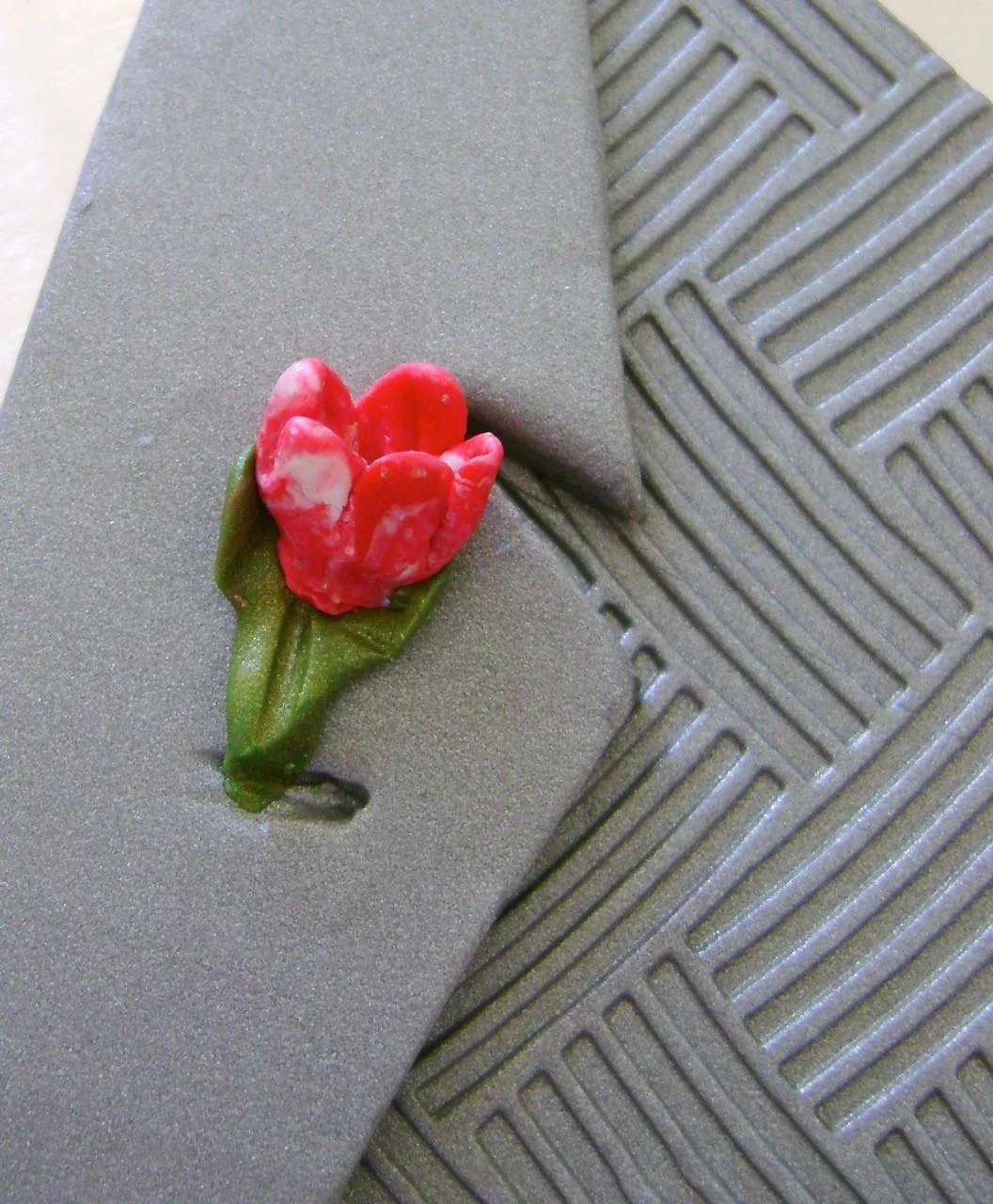 step 15 - Press the boutonniere onto the lapel. Make a gash for the buttonhole.