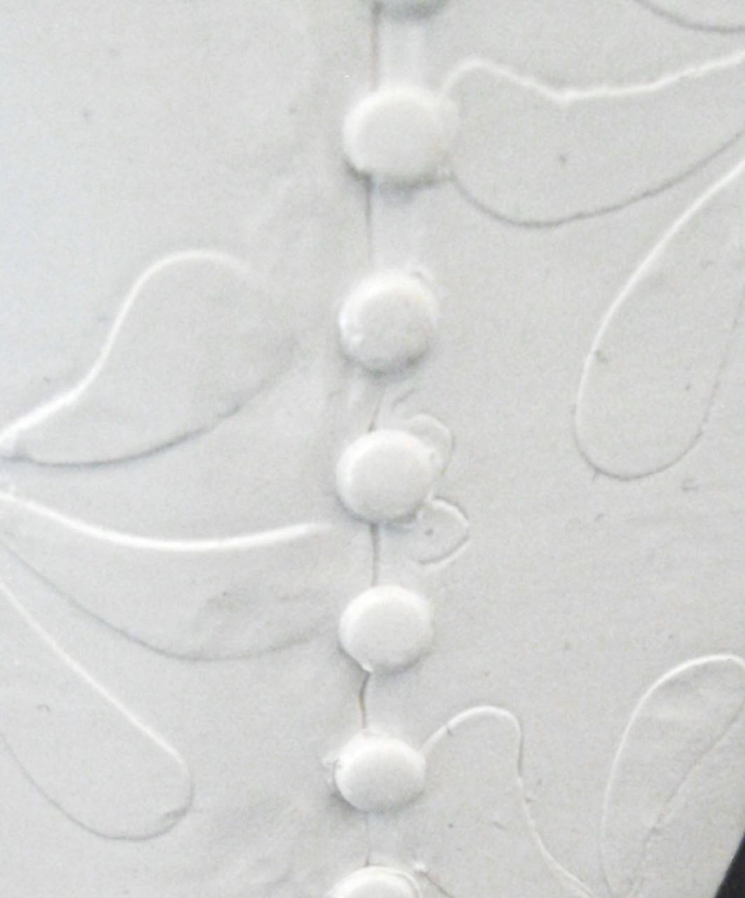 step 11 - Use the round end of a small Etch n’ Pearl tool to cut thirteen round buttons for the back of the sconce. Press them into place.