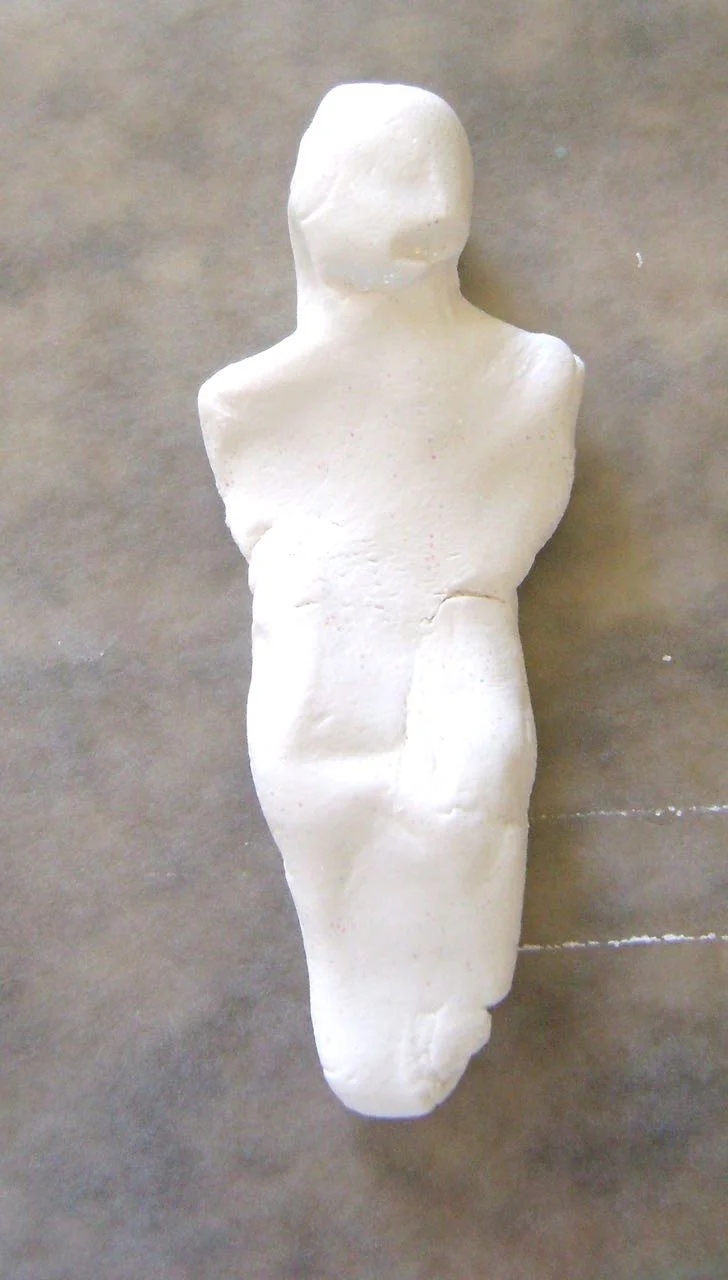 step 1 - Use your hands to form the foundation for the mummy with a clump of clay. It doesn’t have to be beautiful or perfect. Just be sure to include a head shape and shoulders and taper the lower body.