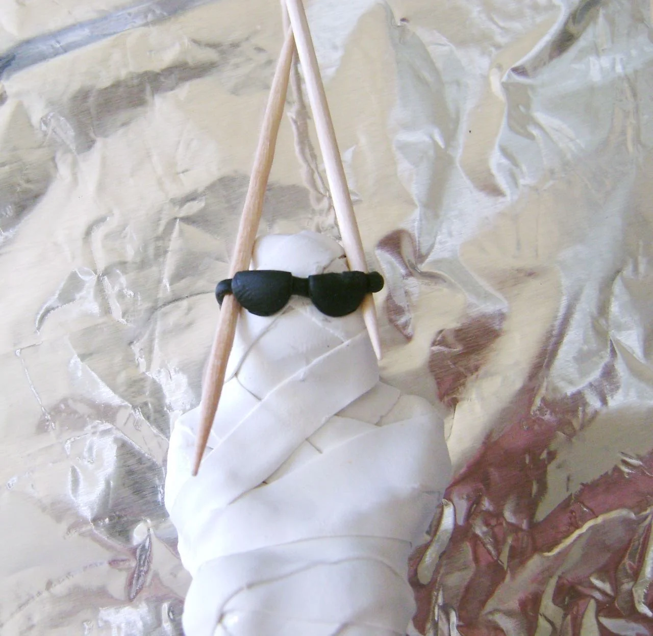 step 9 - Set the mummy on it’s back on a foil lined baking sheet. Bake at 275 degrees for 30minutes. Allow the clay to cool completely before handling. 