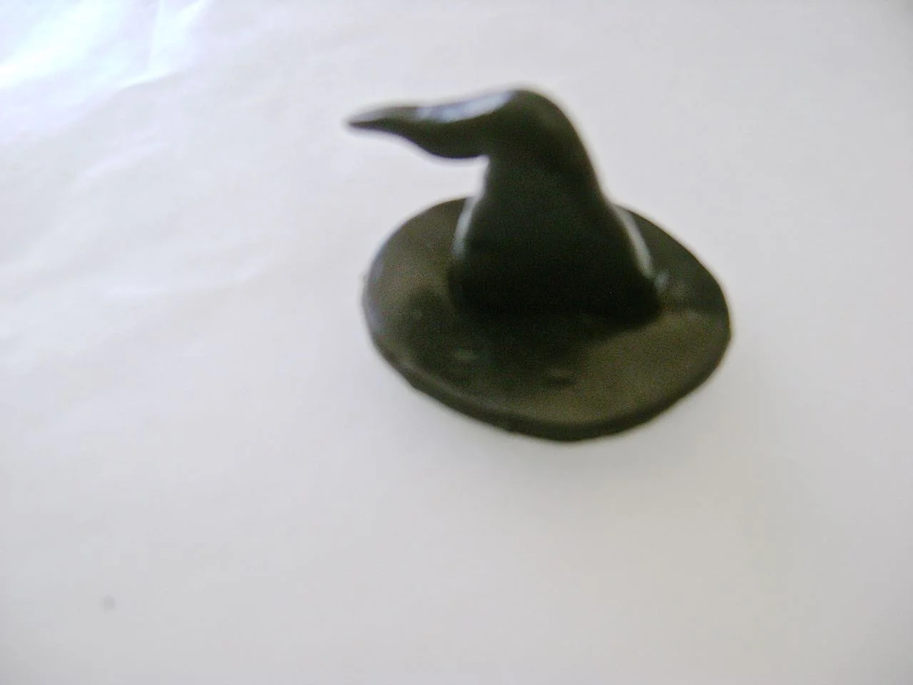 step 8 - Press the tube onto the center of the brim. Use your knuckle to make space under the center of the brim for the witch’s head. 