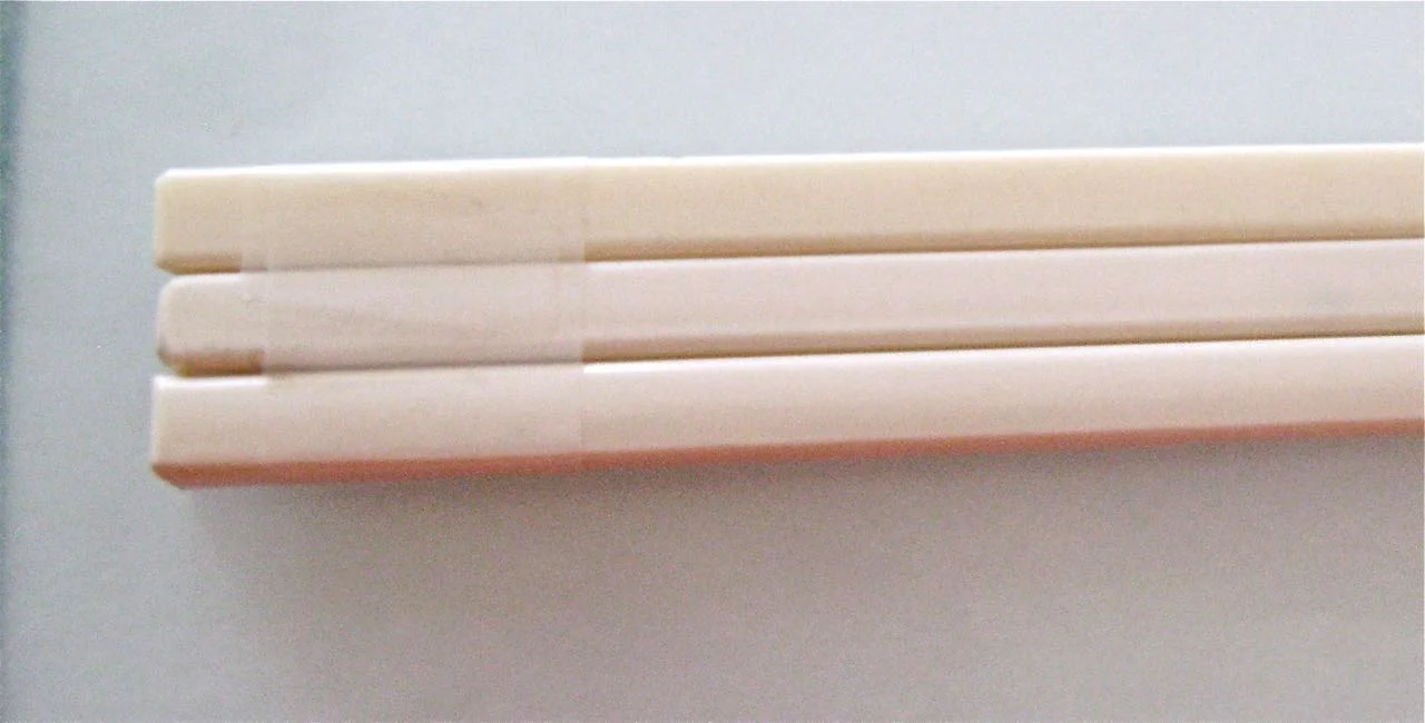 step 2 - The Mirror Handle Wrap scotch tape around the top and bottom of three chop sticks that fit flush with each other. The tape will temporarily hold the sticks in place while you wrap them in clay. Chopsticks can be replaced with any sturdy base for the handle like a piece of yardstick or any wood. The ideal material will be firm but thin. I used chopsticks because it was all that was available when I started this project but thinner material would have been a better aesthetic choice.)