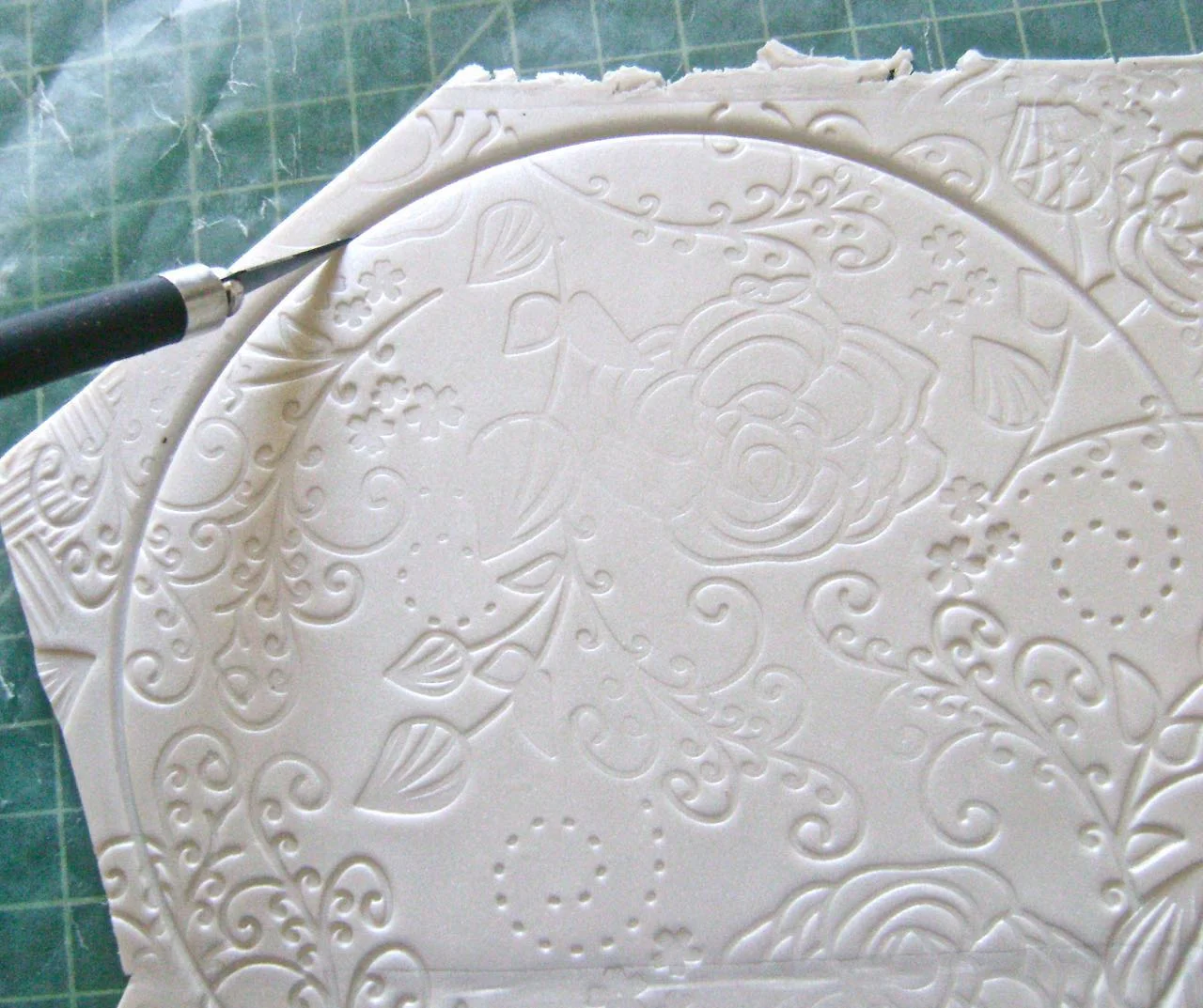 step 7 - Use a craft knife to cut along the round shape made by the lid.