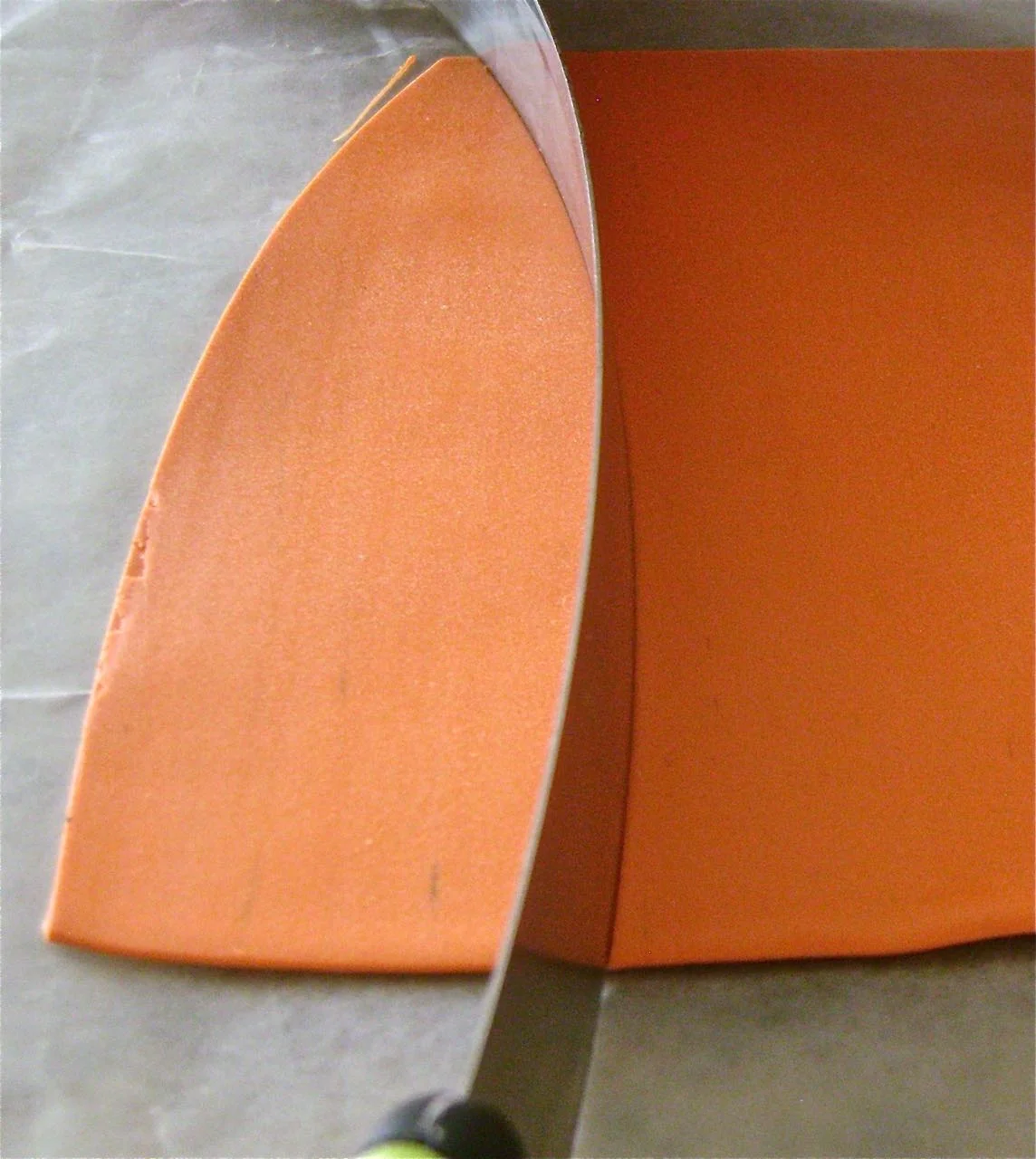 step 2 - Roll out the Pumpkin clay on a number four setting of the conditioning machine. Cut out about seven identical curved shapes using a slicer blade. The shapes should measure approximately one inch at their widest point.