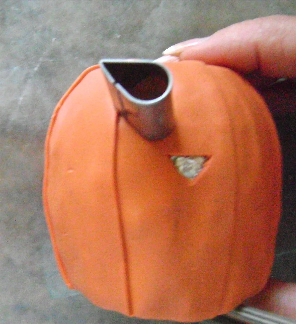 step 5 - With a craft knife, cut out the nose in a triangle shape. Cut eye shapes out of the clay using a teardrop cutter on a slant. 