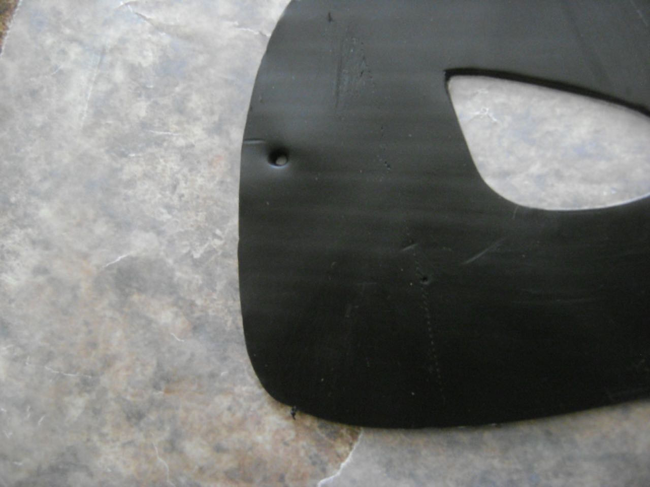 step 6 - Following the markings on the template, use an Etch N Pearl tool to make holes in the sides of the mask. Holes should be large enough to accommodate the cord you will be using for ties.