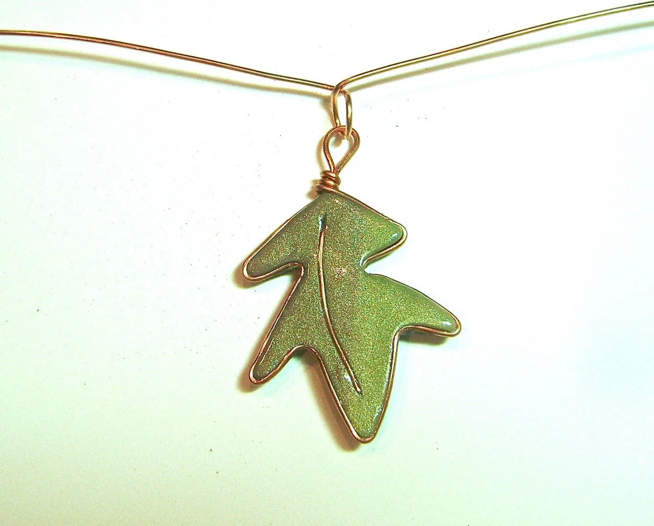 step 10 - Make a loop in the center of a 7” piece of wire and move the leaf into it’s center before twisting the loop.