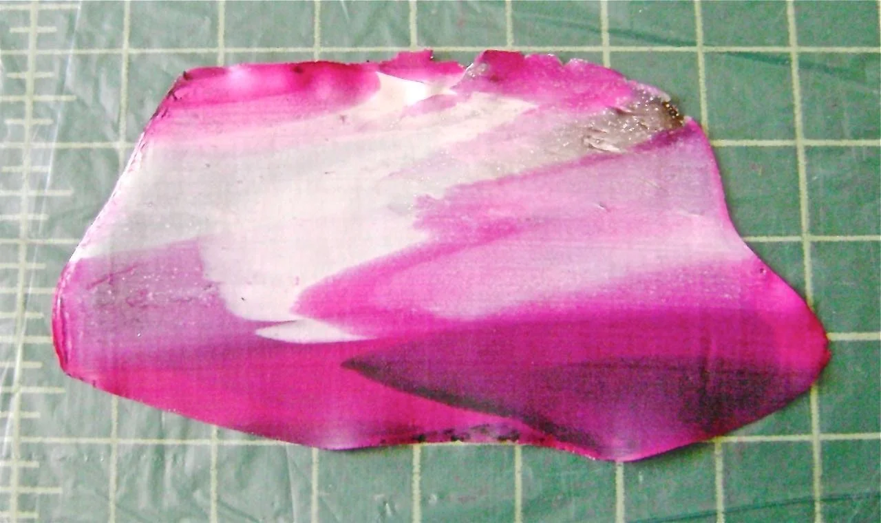step 5 - Put the slices through the conditioning machine starting with a #1 setting. Roll it into a loose log with our hands then pass it through the machine again. Fold in half and pass it through again on a thinner setting. If you pass a rectangular shaped clay through the machine multiple times, you will only stretch the colors vertically. Try also feeding the clay horizontally to stretch colors across the piece. Continue on a very thin setting until you've reached pattern of color blends you like.