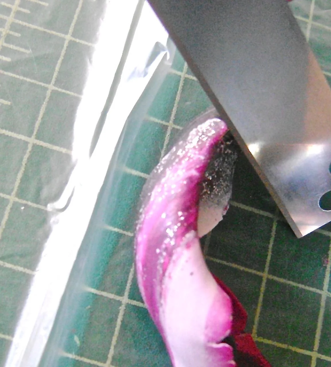 step 10 - Using a blade at an angle, run along the edge of the form to trim the excess clay from the edges. If necessary, cover the bracelet with plastic and smooth the edges again. 