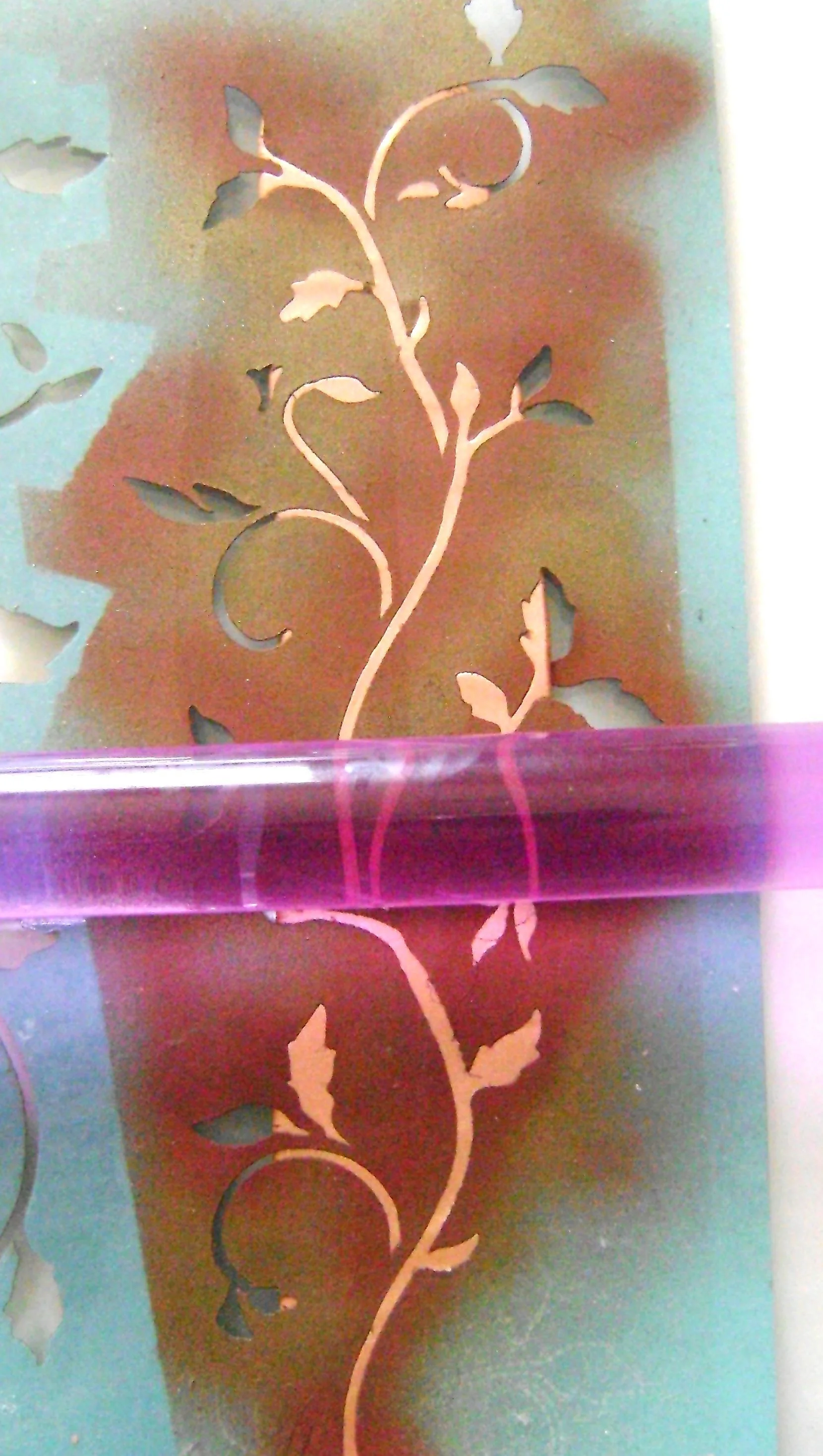 step 2 - Condition 2 oz. of Copper clay on the thickest setting of a clay conditioning machine. Cut the clay into one-inch strips. Place the stencil on the clay and roll over it to transfer the design to the clay. Cut into three strips measuring 7/8” wide and 7”, 8” and 6” long. Use clay-shaping tools to create a curl on the upper and lower strip ends.