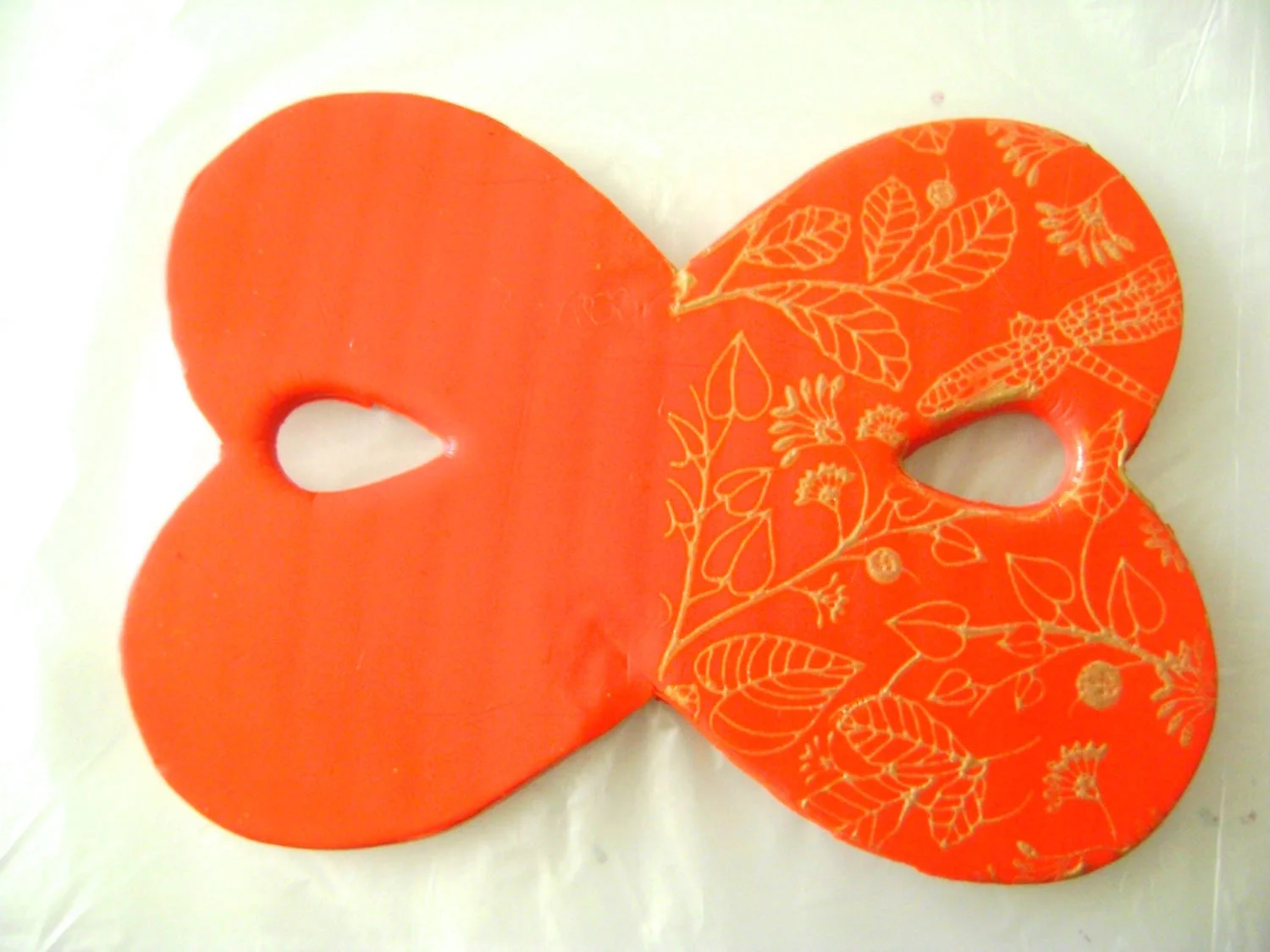step 6 - When you’re sure the clay is covered, peel off the stencil and allow paint to dry. It only takes a few minutes. Immediately rinse the paint off the stencil and squeegee with water. Turn the silkscreen to cover the other half of the clay. Be sure the tape line is in the center.