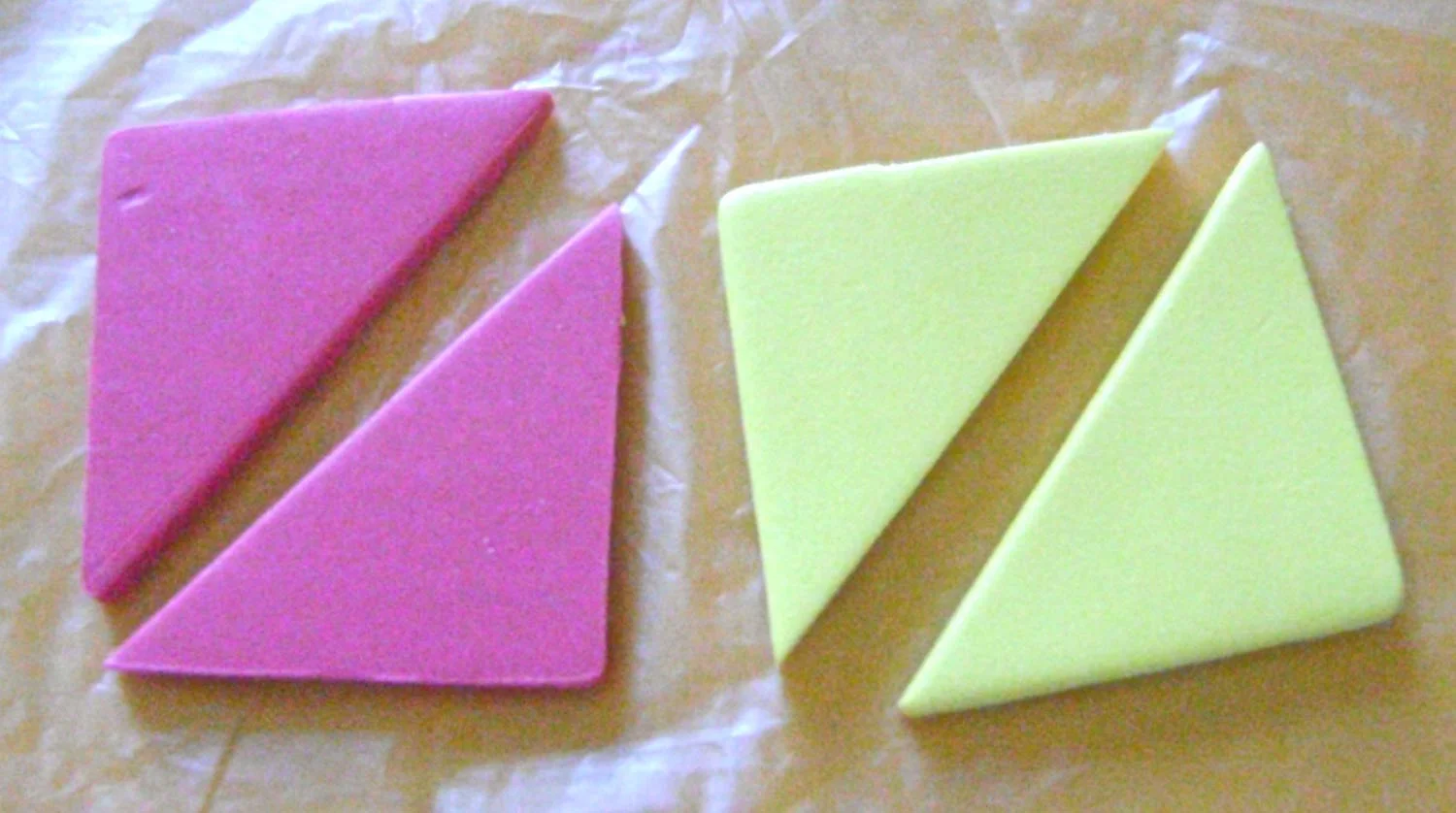 step 1 - Roll the pink and yellow clay with the conditioning machine set on #1. Use a blade to cut a 3” square from each piece. Then cut each diagonally. (Due to lighting problems in my work room, not all of the clay colors in the step photos are represented with accuracy.)