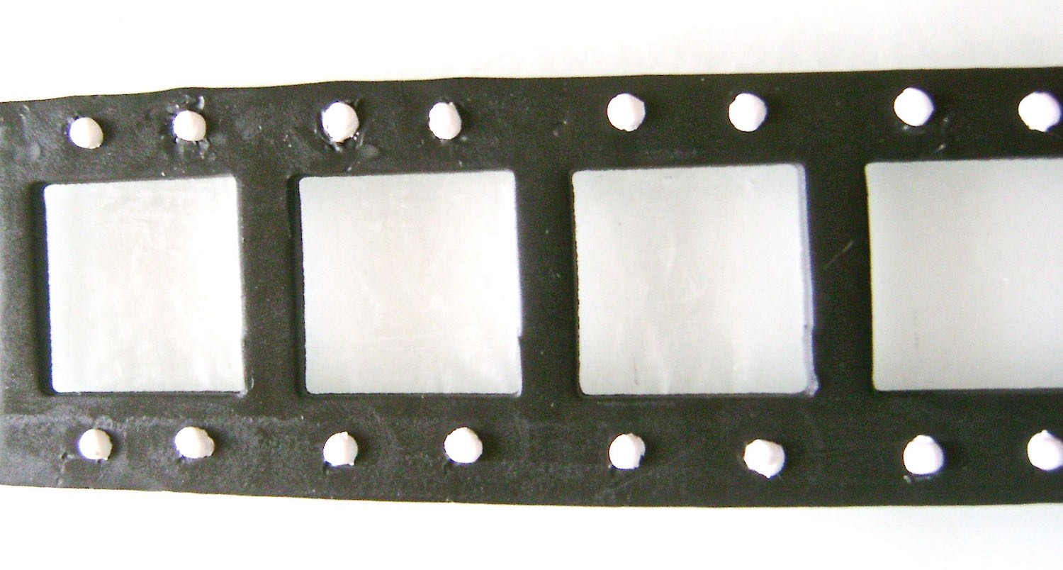 step 7 - Place the dots in the black borders on the clay and press down gently to hold them in position.