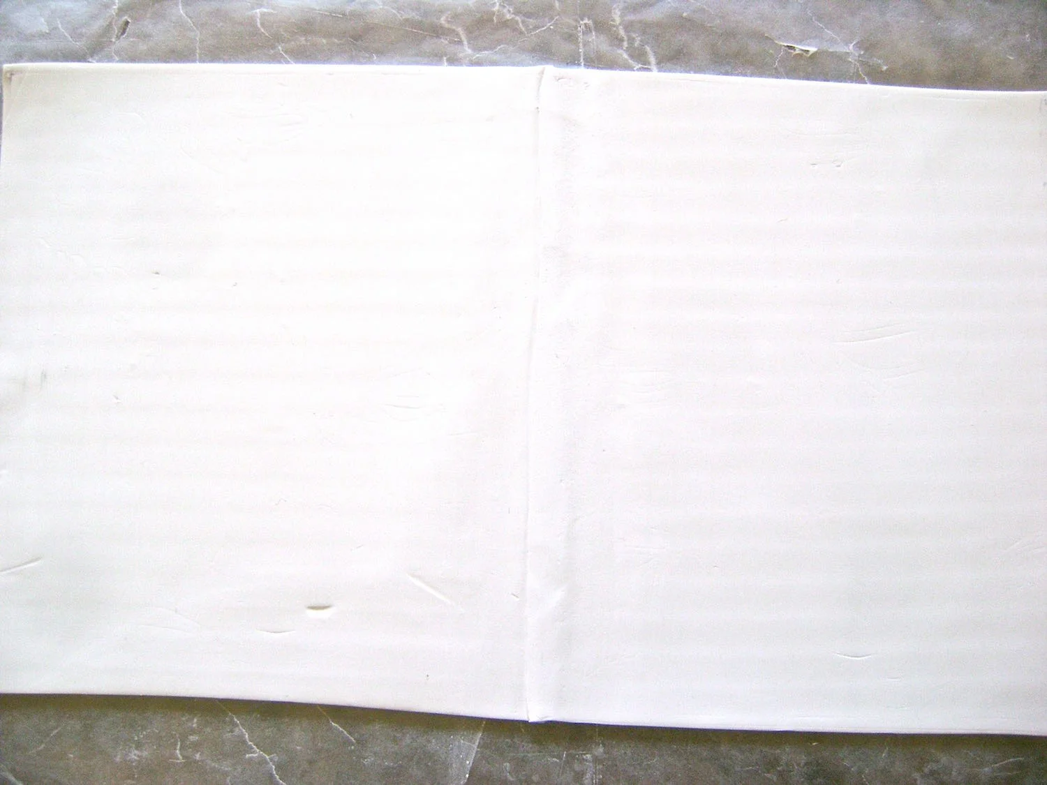 step 4 - To make the clay ring, roll out the clay on #1 setting of the clay conditioning machine. Use a blade to cut the clay to fit the width and length of the image template.