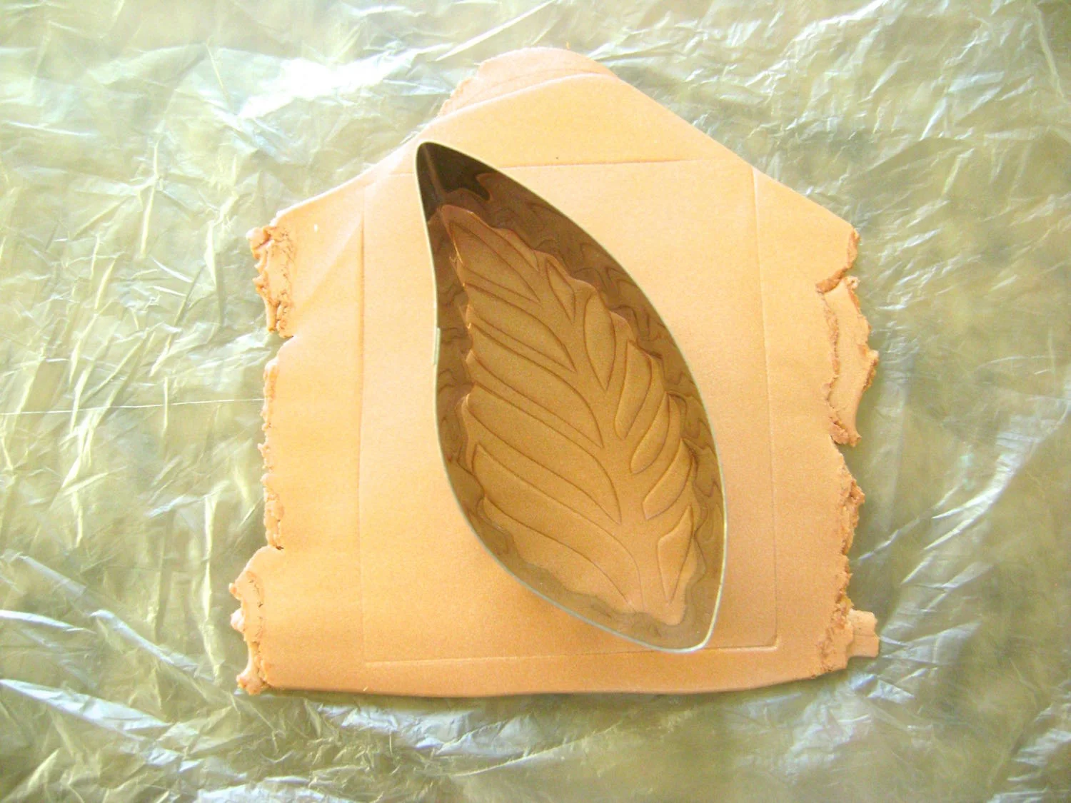 step 8 - Wrap the clay around a toilet paper roll. Don’t stretch the clay in the process. Blend the ends together using your fingers until the seam is invisible.