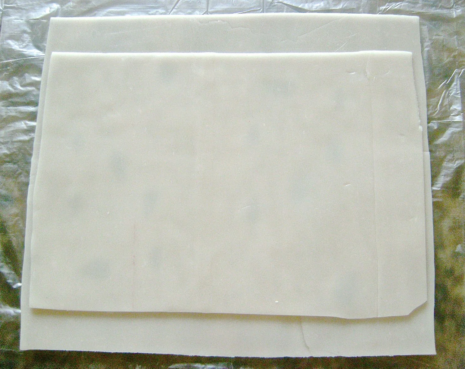 step 9 - Flip the clay over and press the smaller translucent rectangle onto the clay to cover the leaf cut outs.