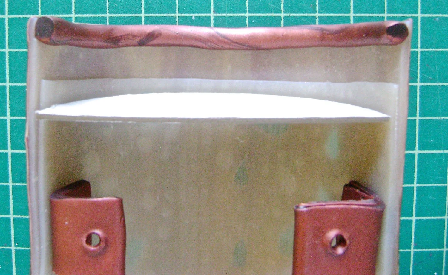 step 14 - The bracelet should still be face down on the parchment paper. Press the extension face down onto the last bead in the strand. Flatten the thick end of the extension so it transitions more smoothly into the bead. The photo above shows how the finished extension looks right side up.