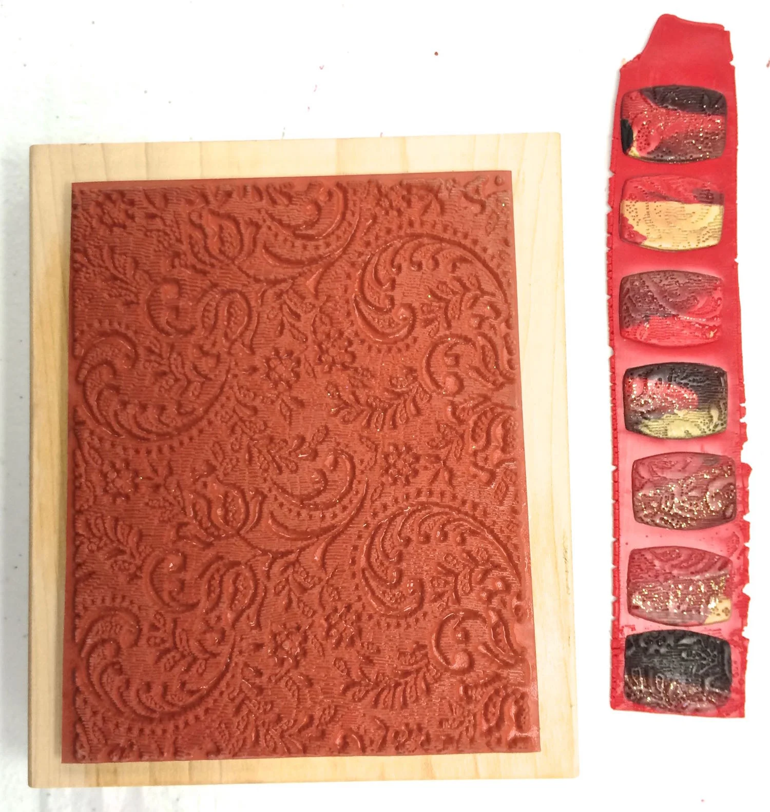 step 6 - Moisten your rubber stamp with water from a spray bottle. Press the stamp onto the beads. Use any size or design stamp as long as the pattern is small enough to cover the complete bead. 