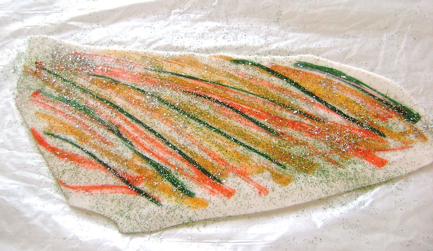 step 4 - Sprinkle glitter on the clay. Avoid getting too close to the edges (like I did).