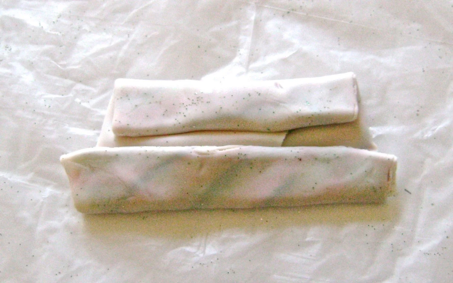 step 5 - Fold the clay in half with the ink and glitter inside. Fold the edges over to seal the contents then fold in half again. 
