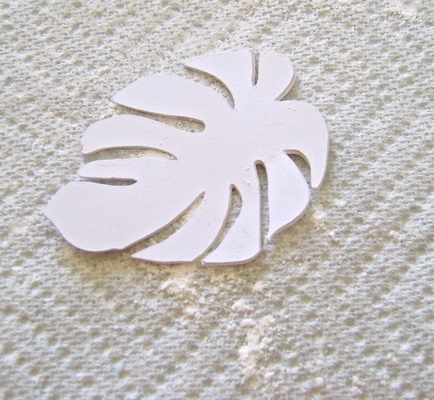 step 5 - Shake baby powder onto a paper towel. Rub the wrong side of the paper image against the powder which will prevent clay from sticking to the card stock. 
