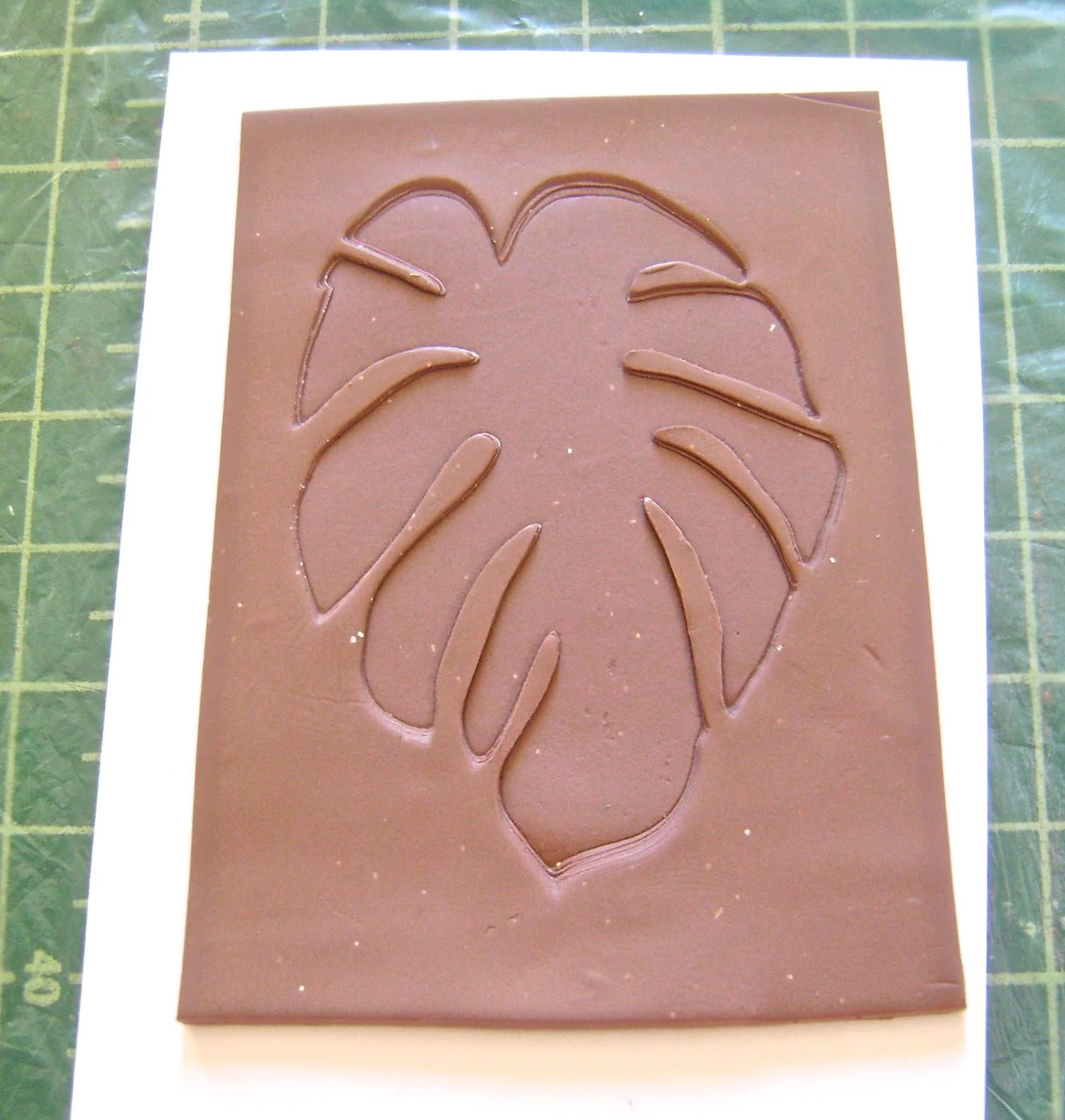 step 7 - Carefully remove the card stock from the clay. Trim the texture sheet leaving a border all around the image for easy handling. Bake the clay on pieces of card stock or cardboard at 275 degrees for 30 minutes. Allow them to cool completely. 