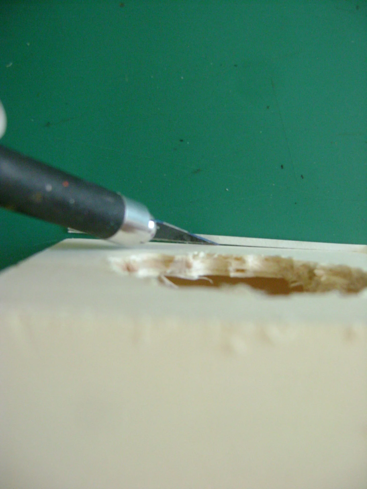 step 2 - Cut a hole for the vase in the center of the top panel using a box cutter, craft knife, or saw.