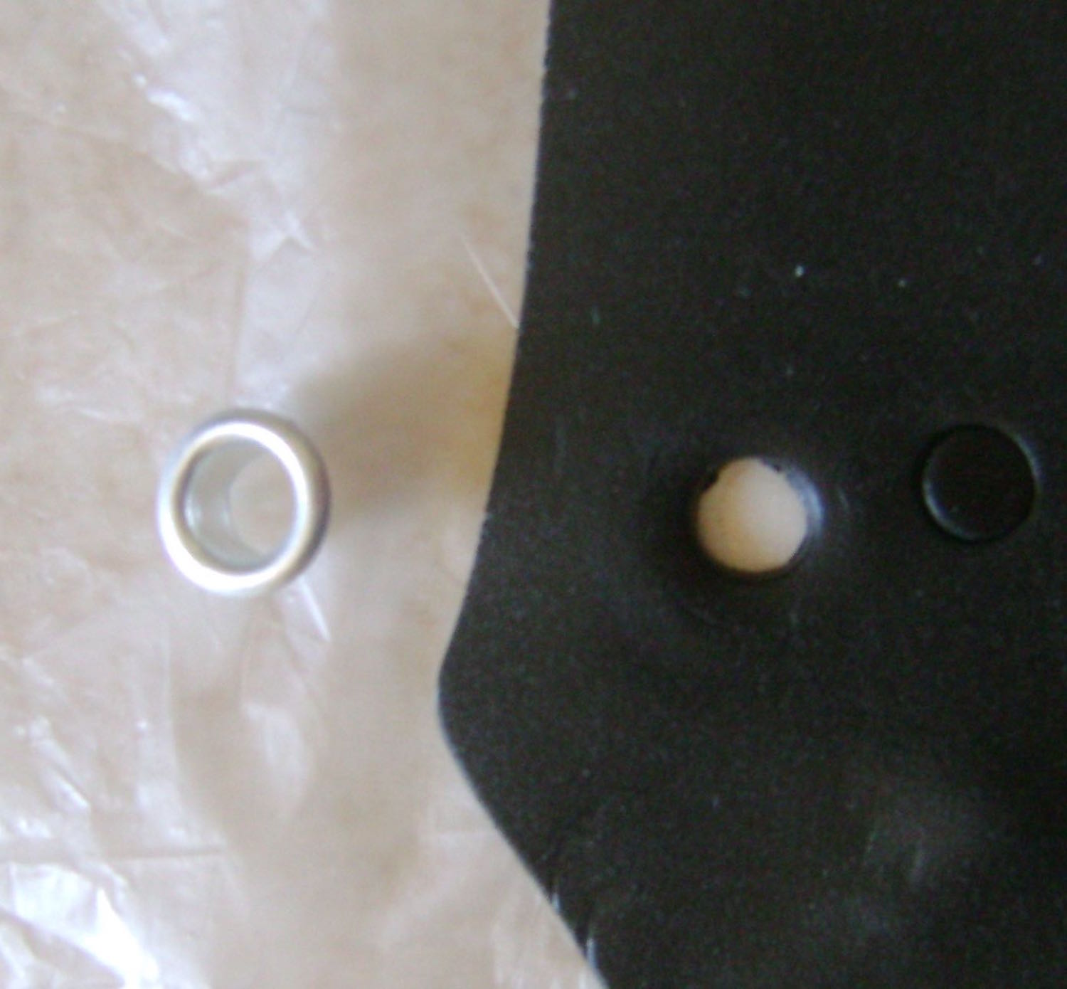 step 3 - Roll a small piece of black clay on the #2 setting of the conditioning machine. Do the same with a scrap of blue. Cut two black eye circles using an eyelet or other small object.