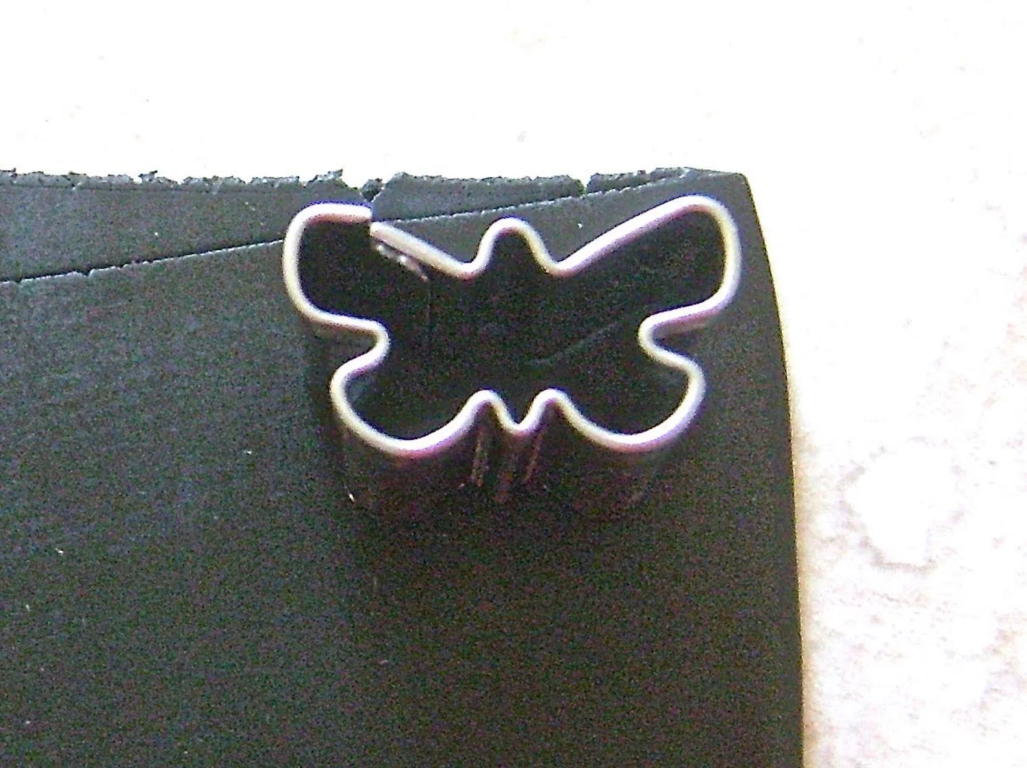 step 1 - Roll out conditioned black clay on setting #2 of the conditioning machine. Use a butterfly cutter (included in Sculpey’s “Nature” collection) to cut out 4 or 5 butterflies. This will be an appropriate thickness for all the clay pieces.