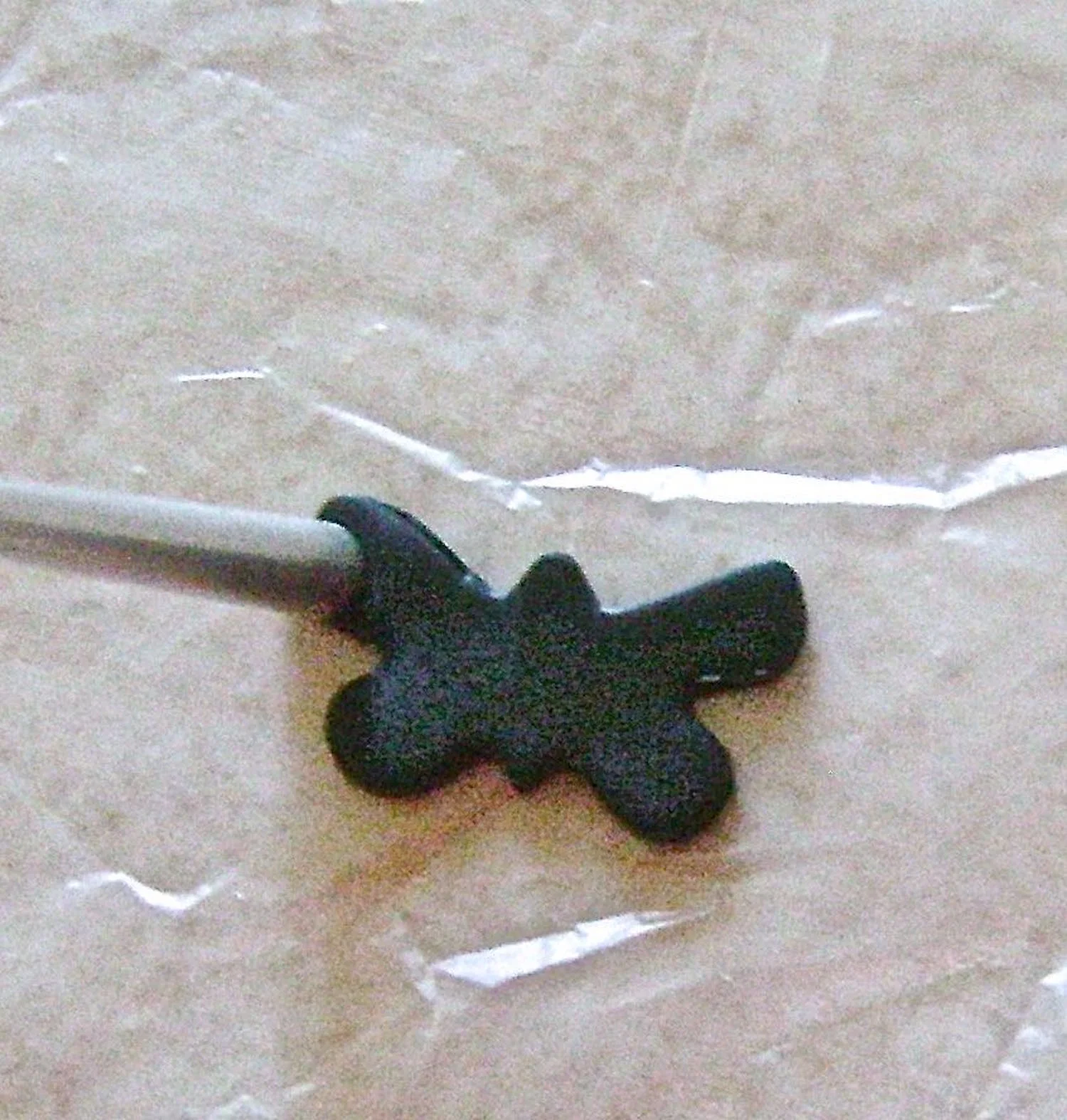 step 2 - Turn the butterflies into bats by pressing the round end of the smallest Etch N Pearl tool to the edges of the wings. Stick the pointy end into the center of the head and pull upward. This will create the bat ears.