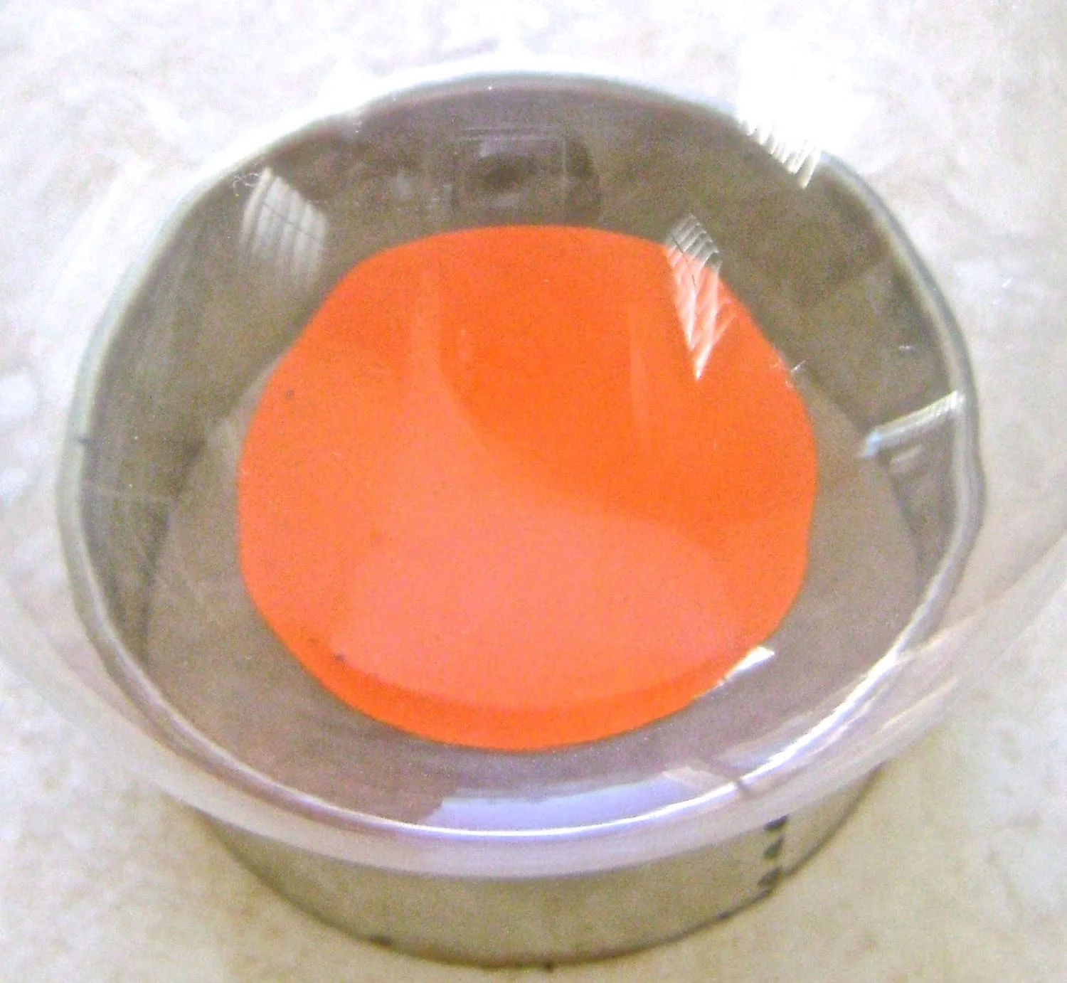 step 14 - Pour a puddle of orange paint into the ornament. Swish it around to cover the entire interior. Place the ornament on a disposable container and let the paint drip out. Don’t waste the paint. Return it to the bottle. Allow the ornament to continue to drain. When the paint is dry, repeat the process with yellow paint. 