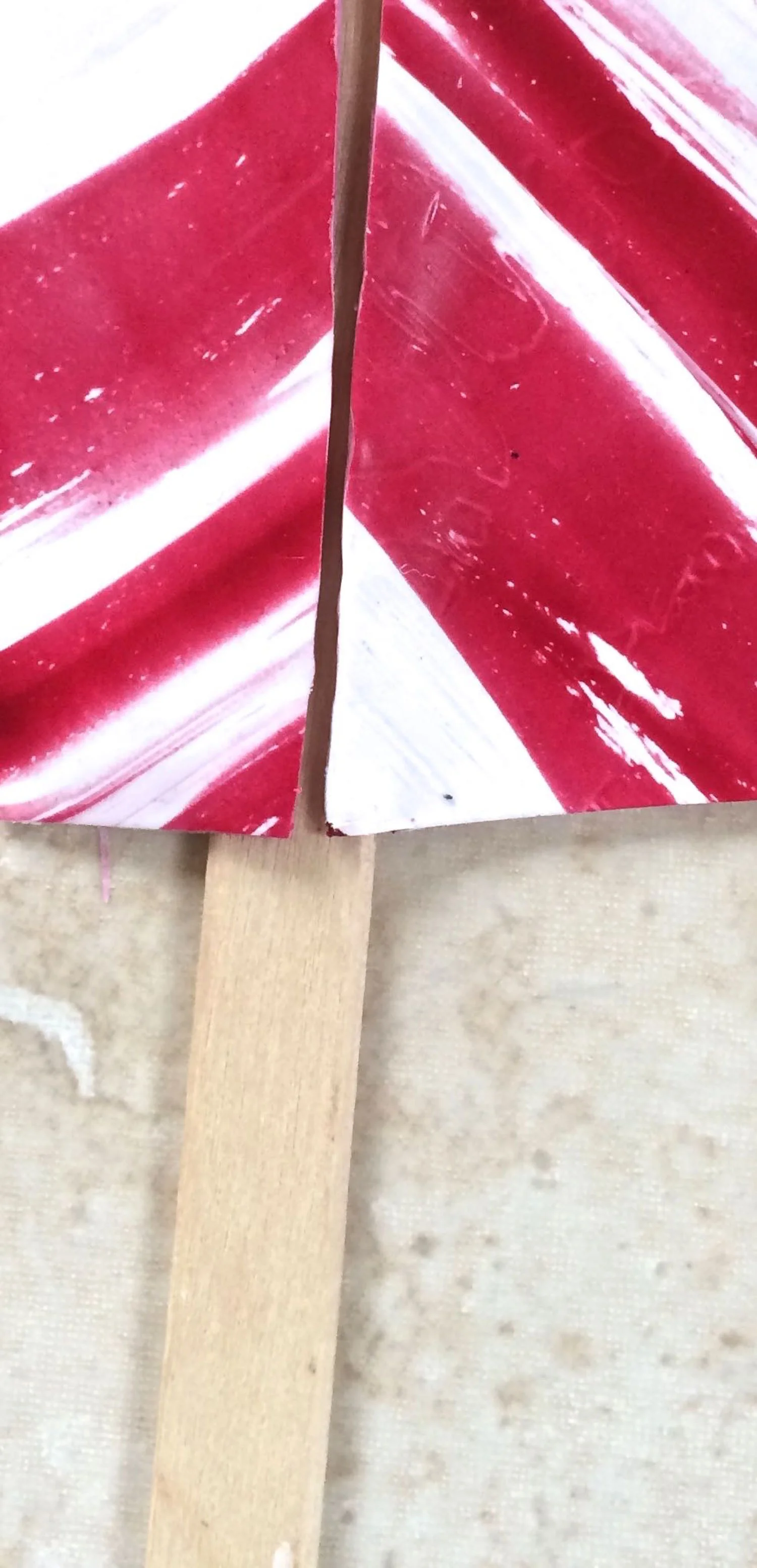 step 3 - Place a craft stick under the straight edges of the clay and pinch them together to form a clay cone. Blend the edges using the stick as support.