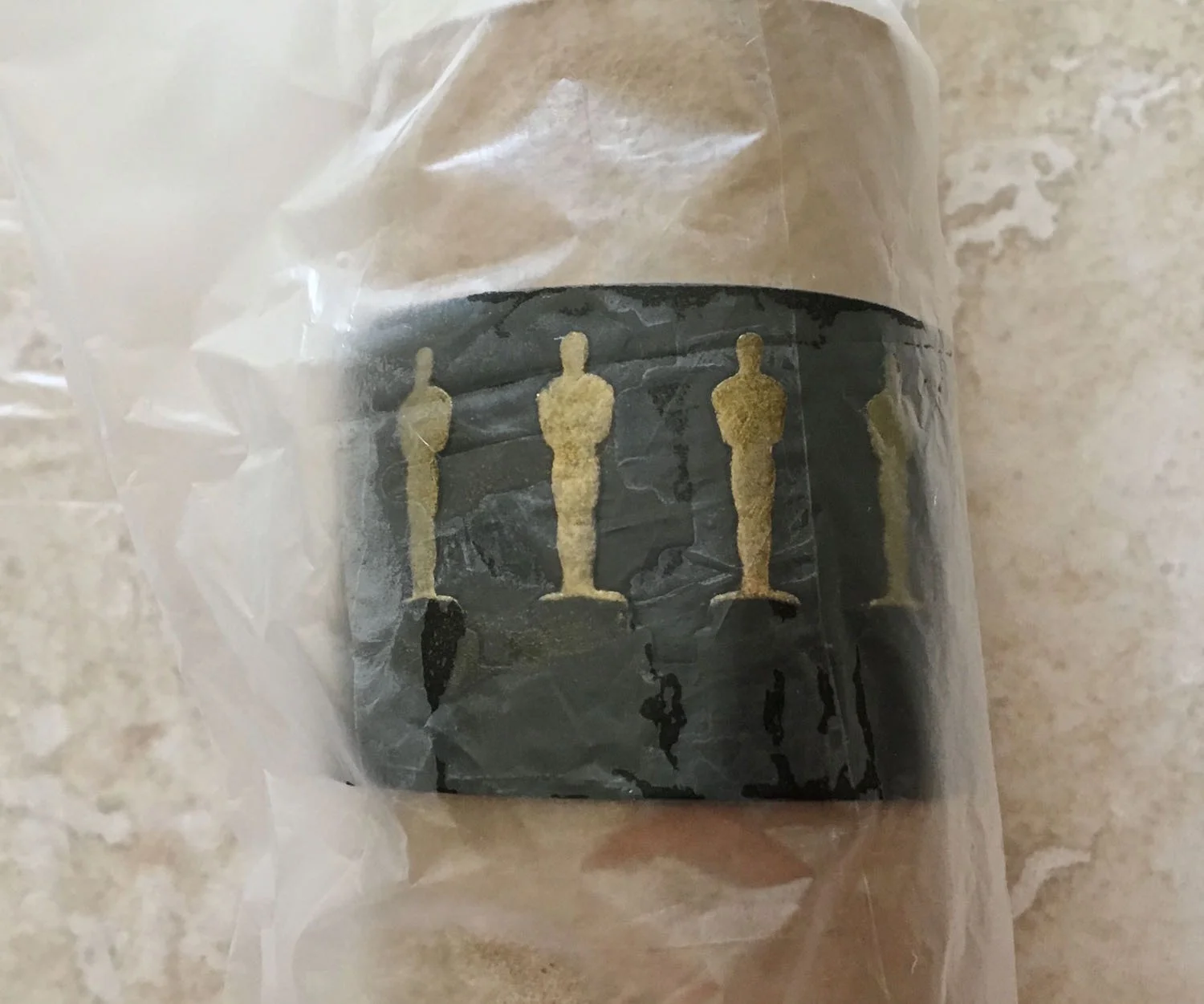 step 10 - Wrap the clay around an empty paper towel roll. Trim the short ends if necessary. Blend the clay edges together. Remove the plastic.