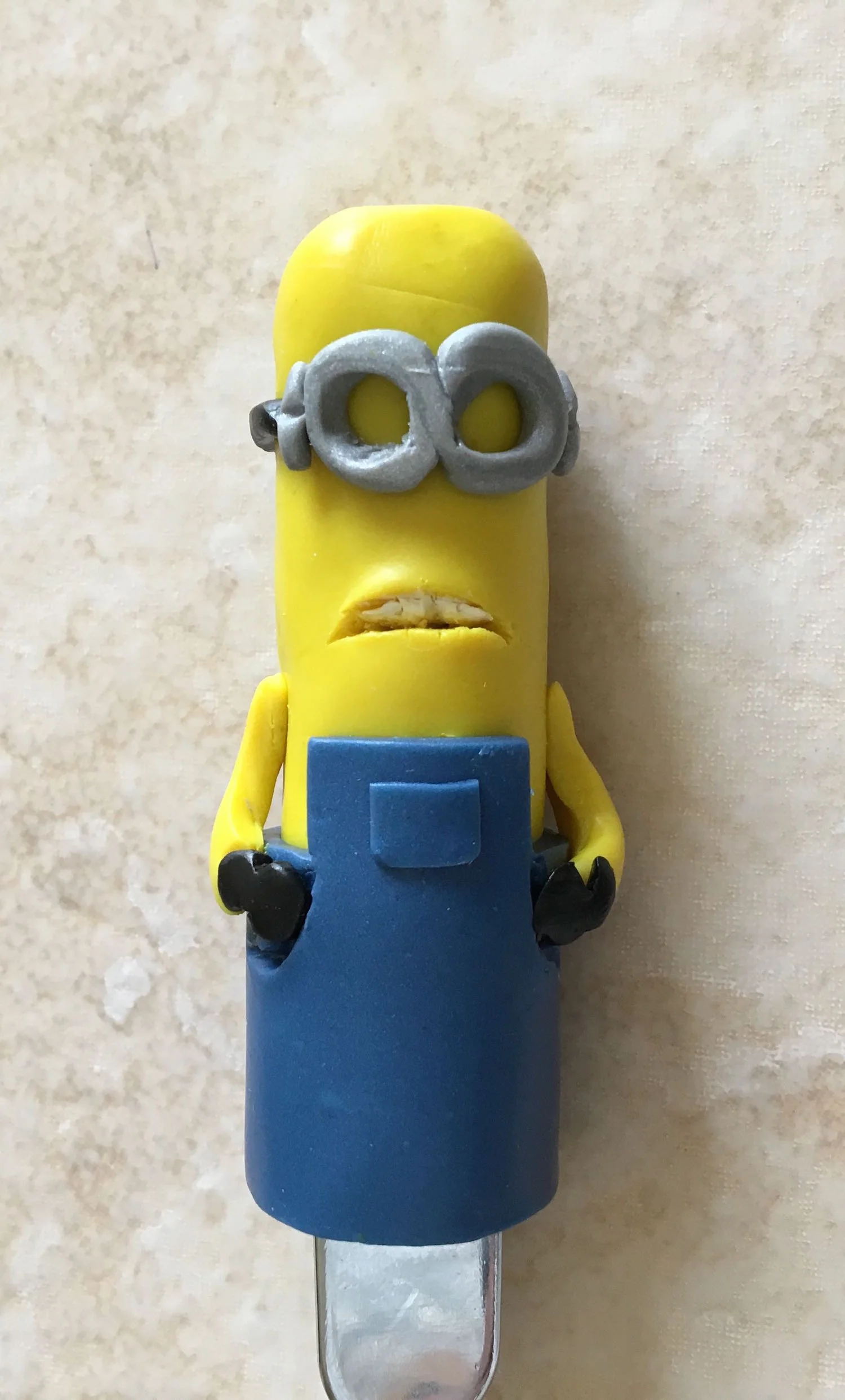 step 12 - Attach the arms to the body slightly below the mouth line. Press the gloves to the pocket lines.