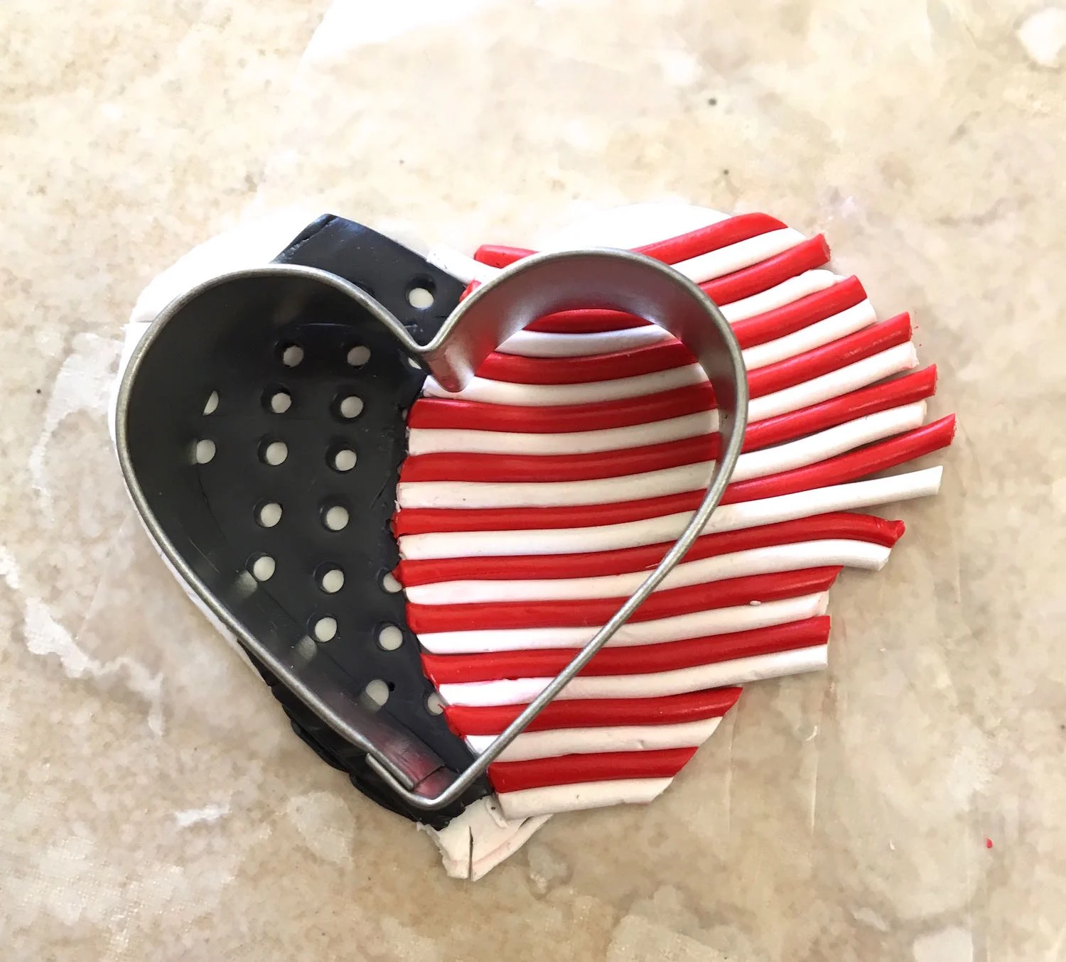 step 8 - Position the small heart cutter over the clay. Flip the cutter over along with the clay.