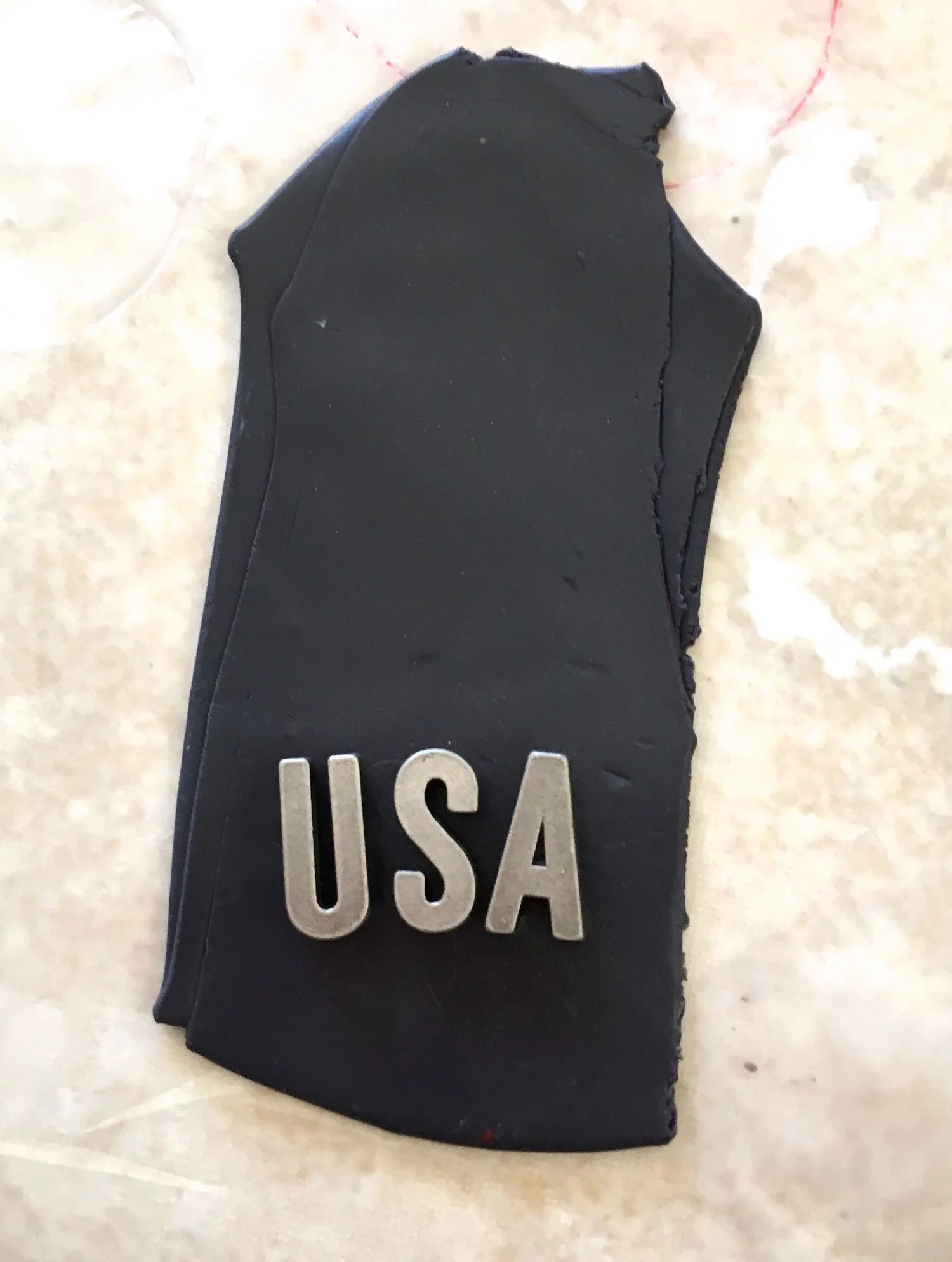 step 12 - Place metal letters on a strip of the navy blue clay. Press them down to leave impressions.