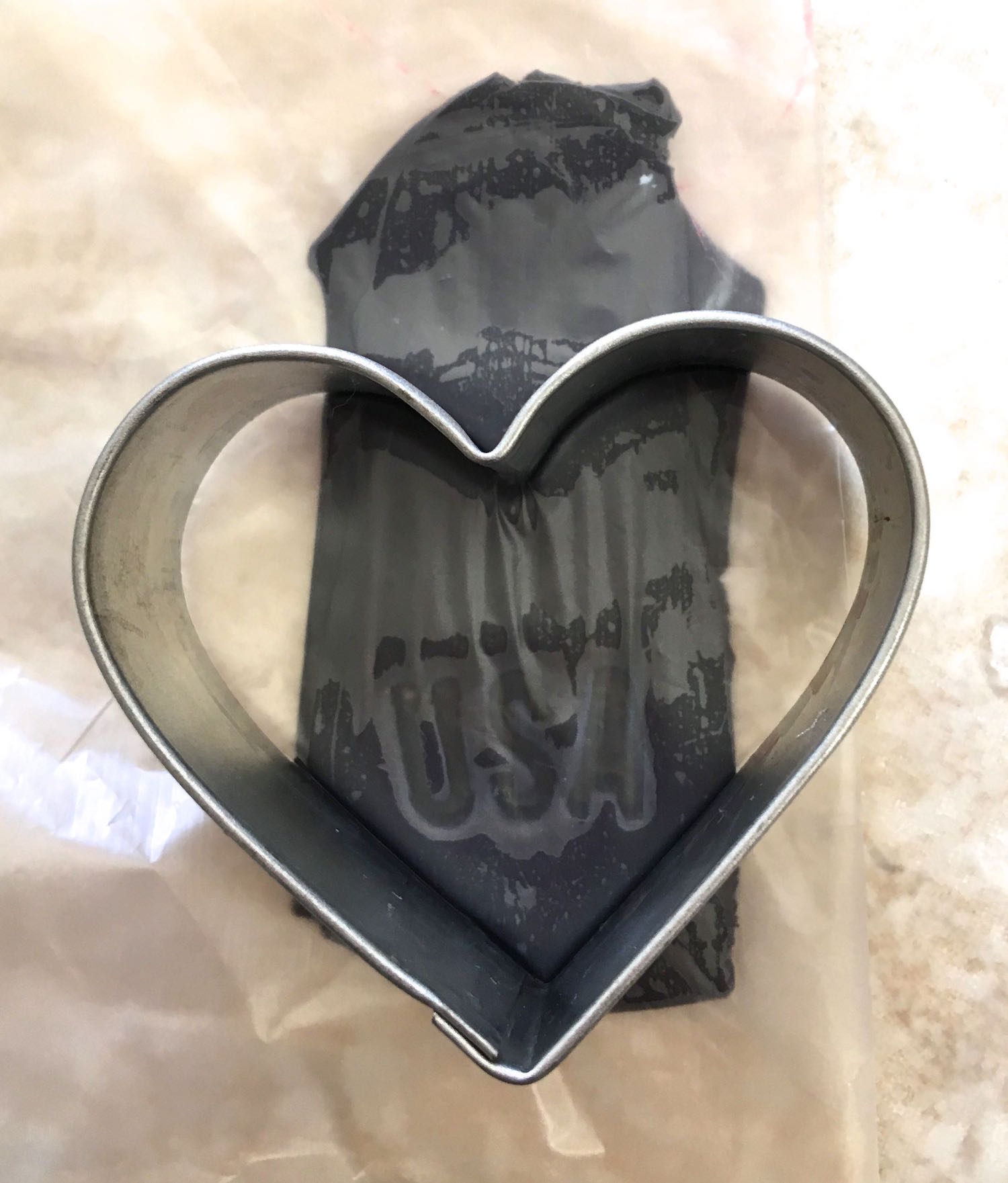 step 13 - Use the point of the heart to shape the end below the letters.