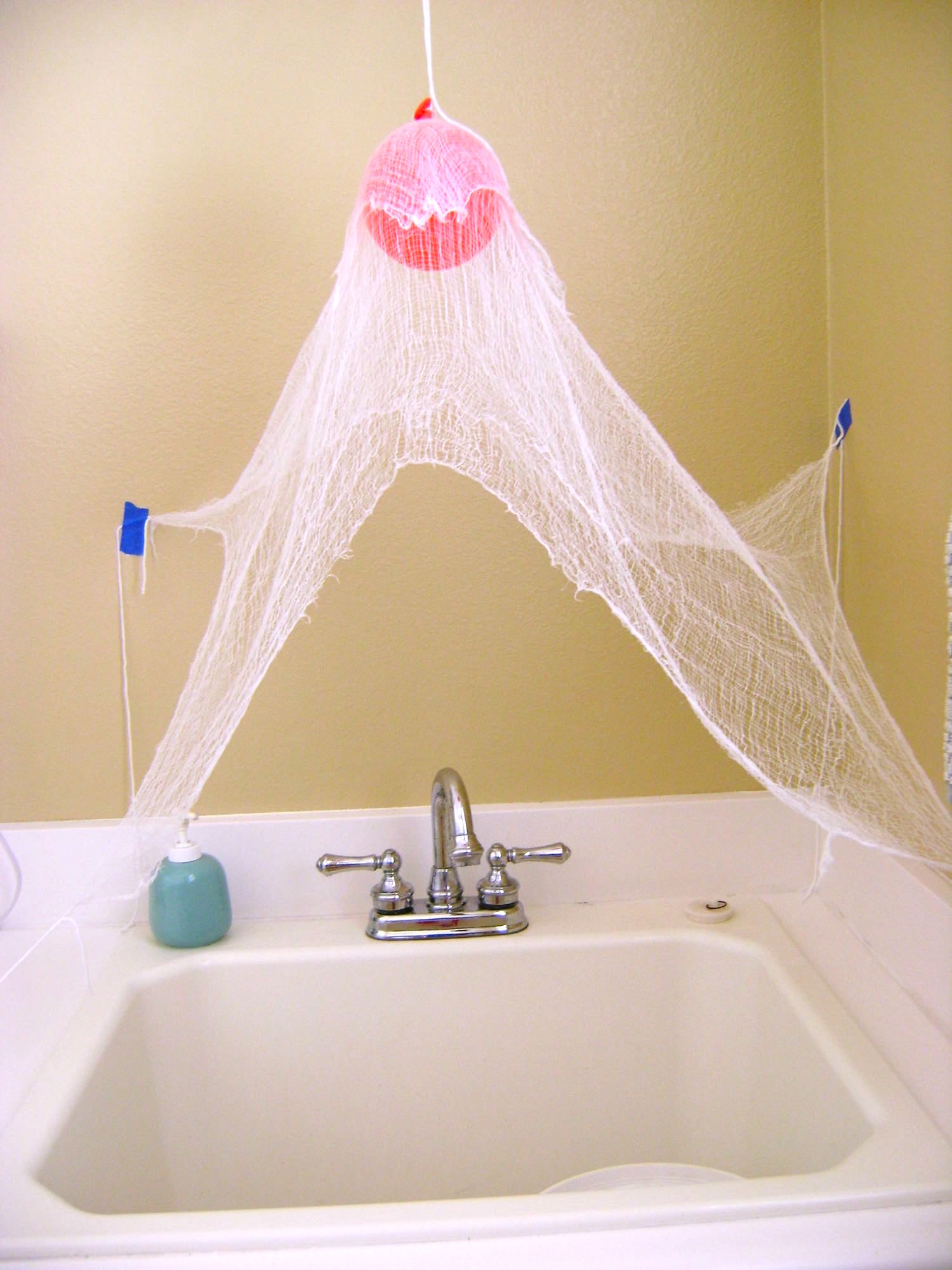 step 3 - Stretch out and tape corners of the cloth as with the large ghost and secure them with tape while they dry. 