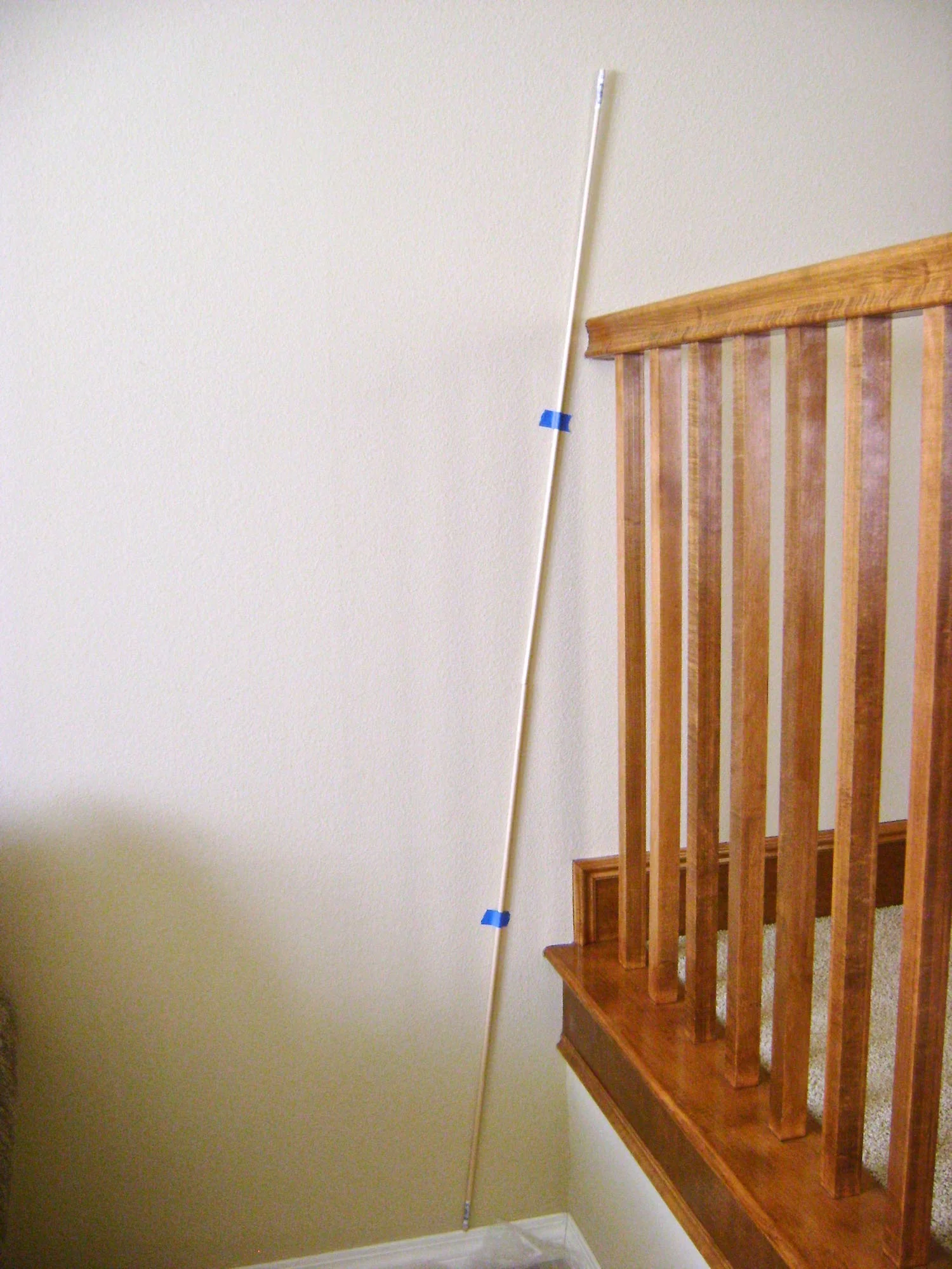 step 1 - Plan the number of trees you will create and their size. If you’re going to angle some trees, tape a yardstick or dowel against the wall as a guide and follow it as you position your stencils.