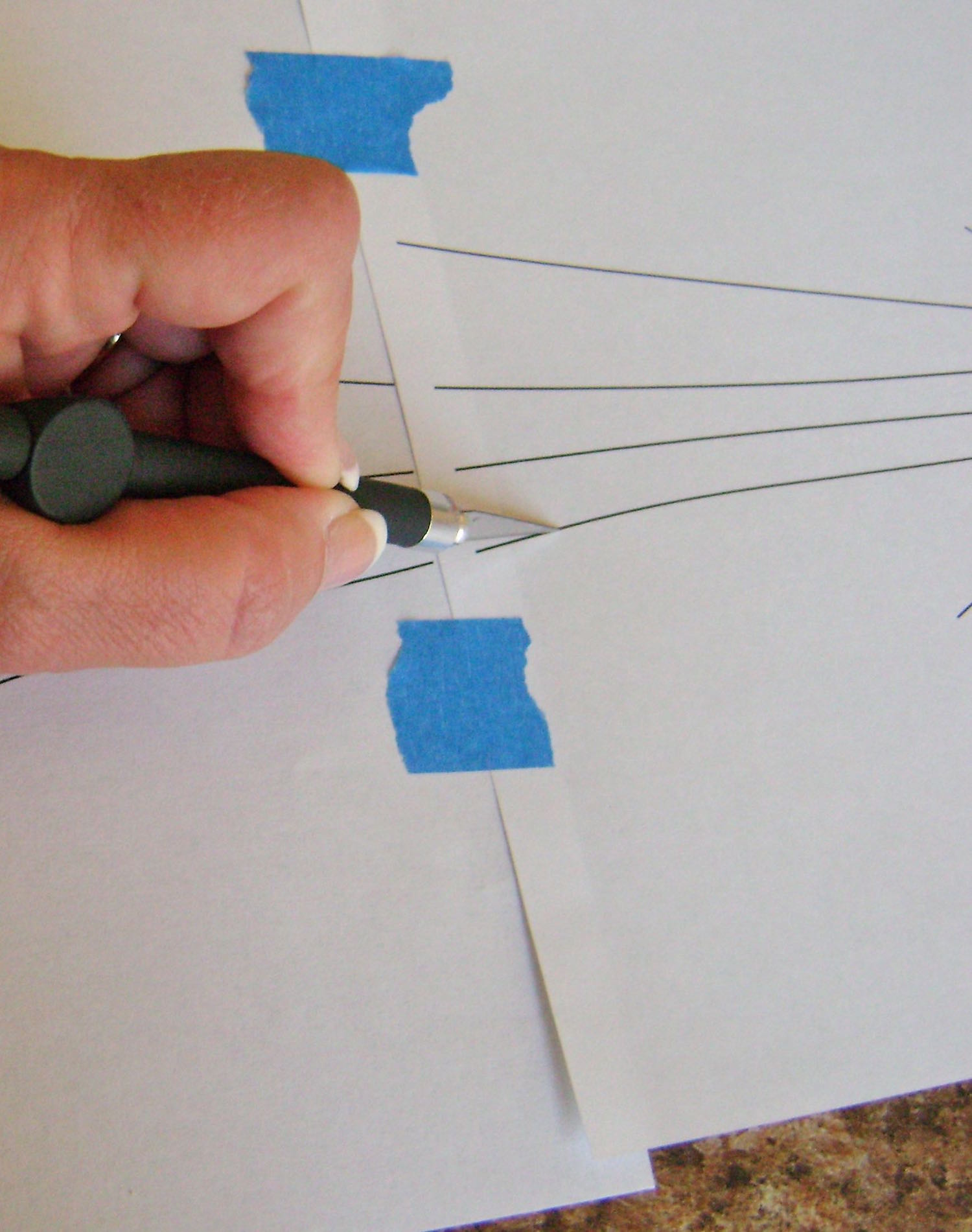 step 3 - While the paint dries, slice through the lines of the template with a craft knife. Poke holes in the circles.