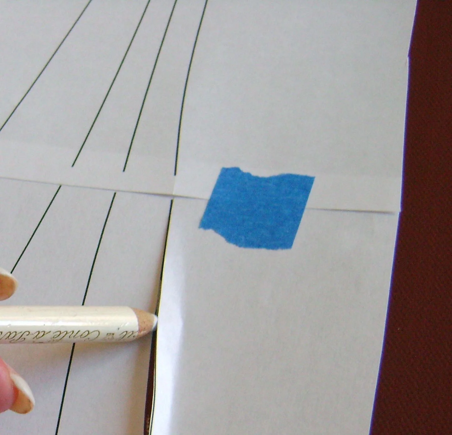 step 4 - Position the template on the canvas. Using a chalk pencil, draw light lines in the slits and dots in the circles.
