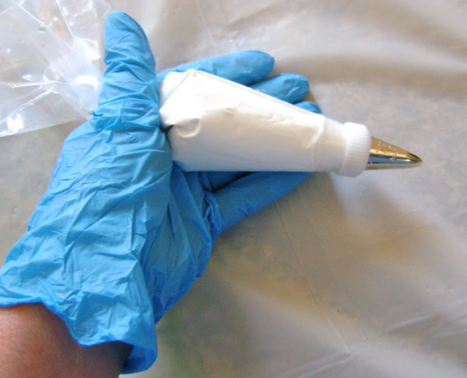 step 13 - Squeeze the contents of the tube into the bag. Unfold the cuff and twist the end of the bag.