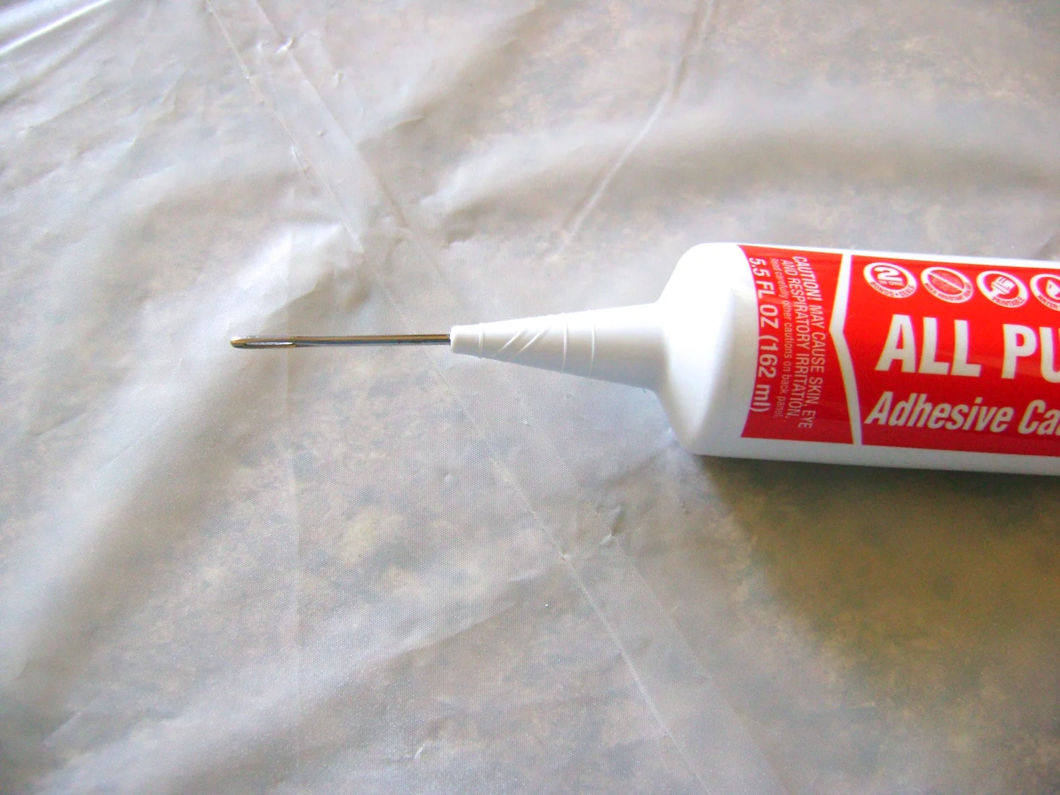 step 7 - Do not cut the tip of the caulking container as suggested on the package. Instead, pierce the tip with a sharp, thick needle or a nail.