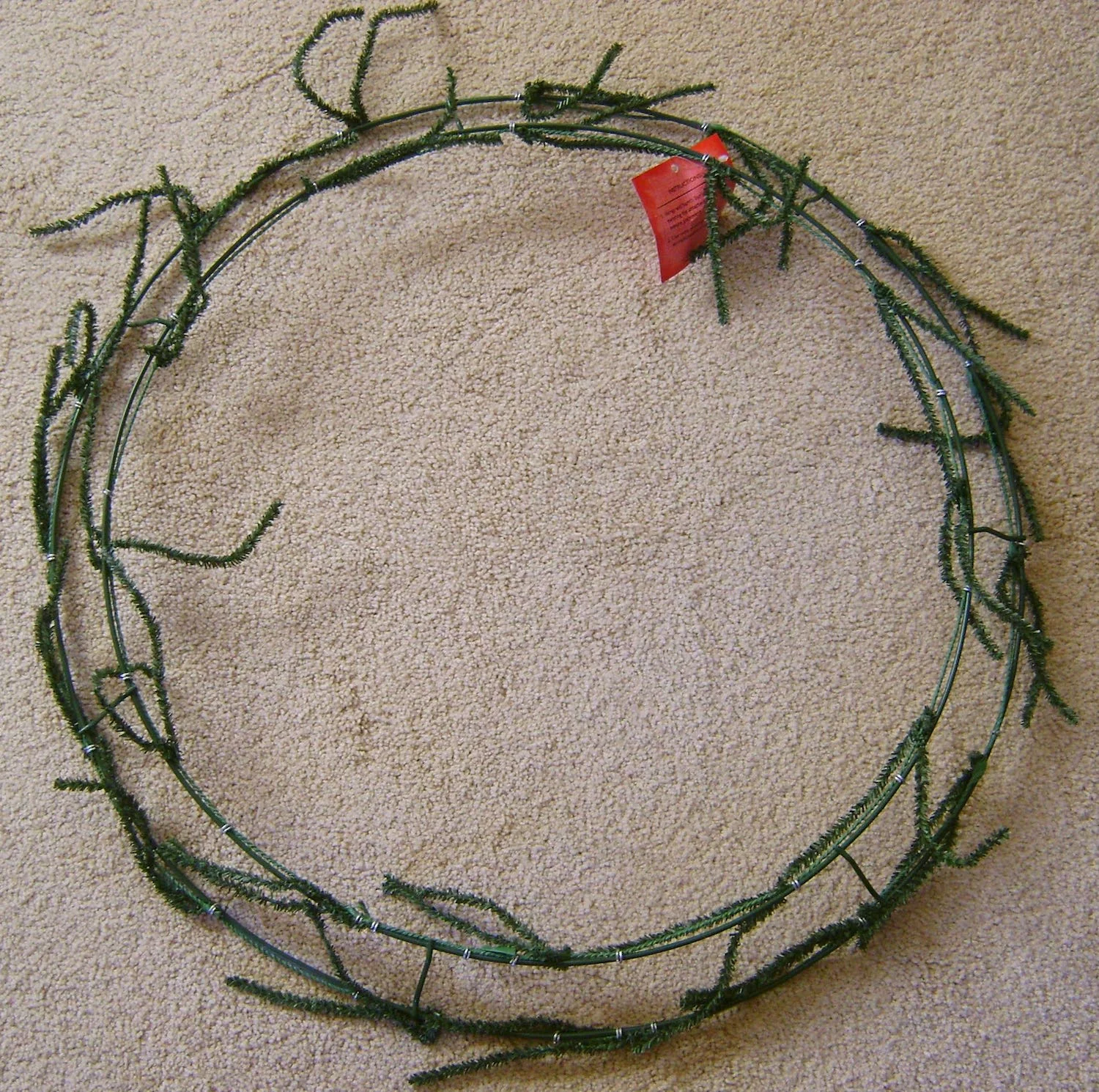 The 24” wreath is made with two circular wires and includes twist ties for attaching decorations.