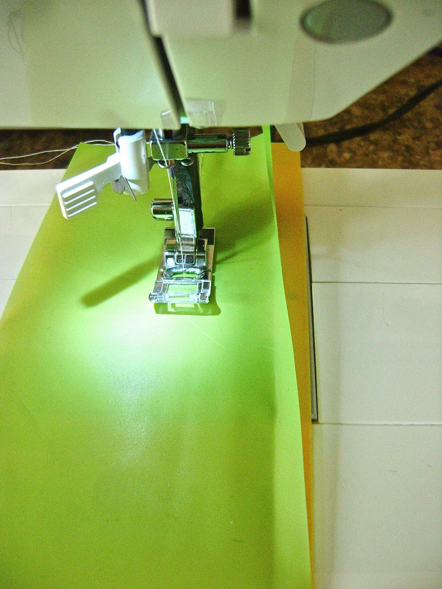 step 4 - Create a “set” by stacking a green, yellow and pink layer with edges aligned. Sew down the length 1.50” from the edge. Sew another line of stitching .50” from the first to create a casing. Sew two more color sets. Sew the white sets by stacking 3 white layers in each set.