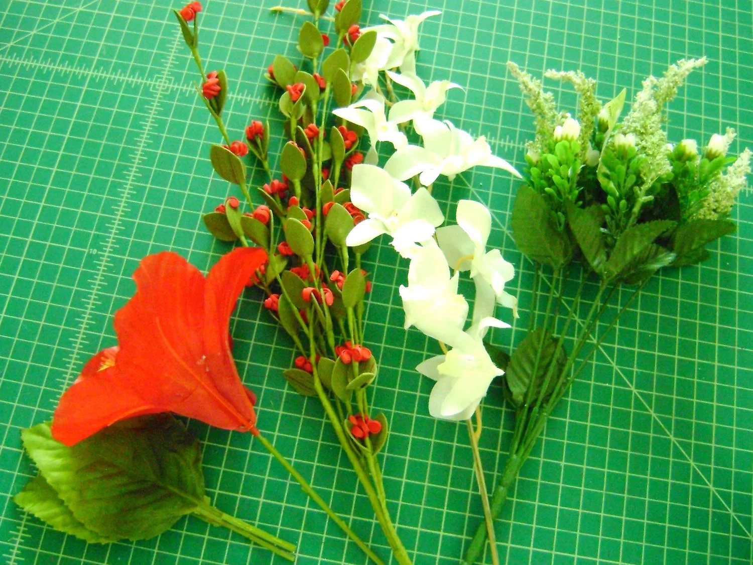 step 2 - Use 3 or 4 different kinds of flowers and sprays mixing sizes and colors. Cut the stems to about one inch long.