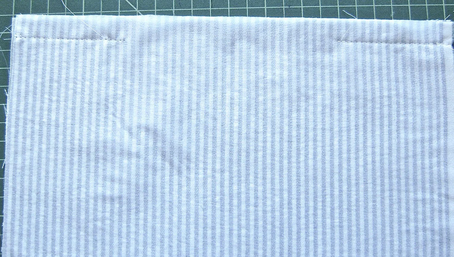 step 1 - Stitch the front and back of the pillow cover on the 12” edge. Leave 8.75” open in the center. Machine baste the 8.75” opening.