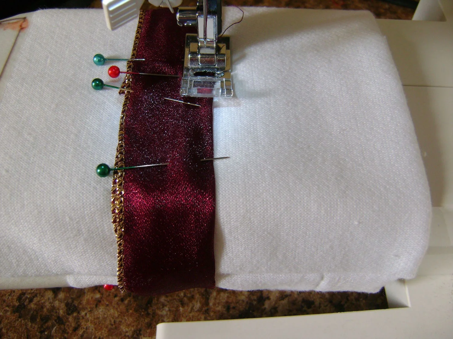 step 10 - Machine stitch around the top and bottom of the ribbon.