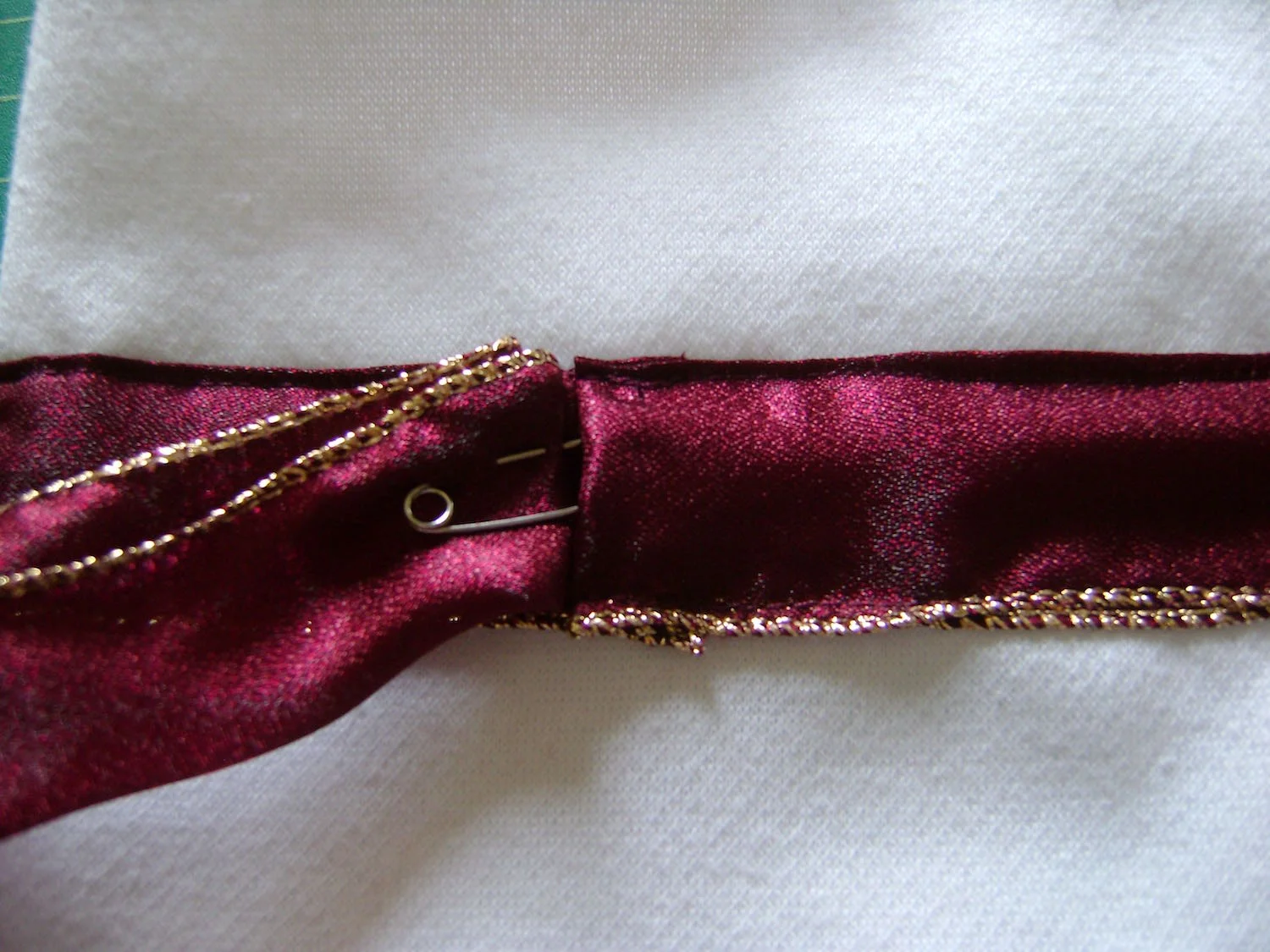 step 11 - Cut a piece of 24” long ribbon. Attach a large safety pin and use it to move the ribbon through the casing. 